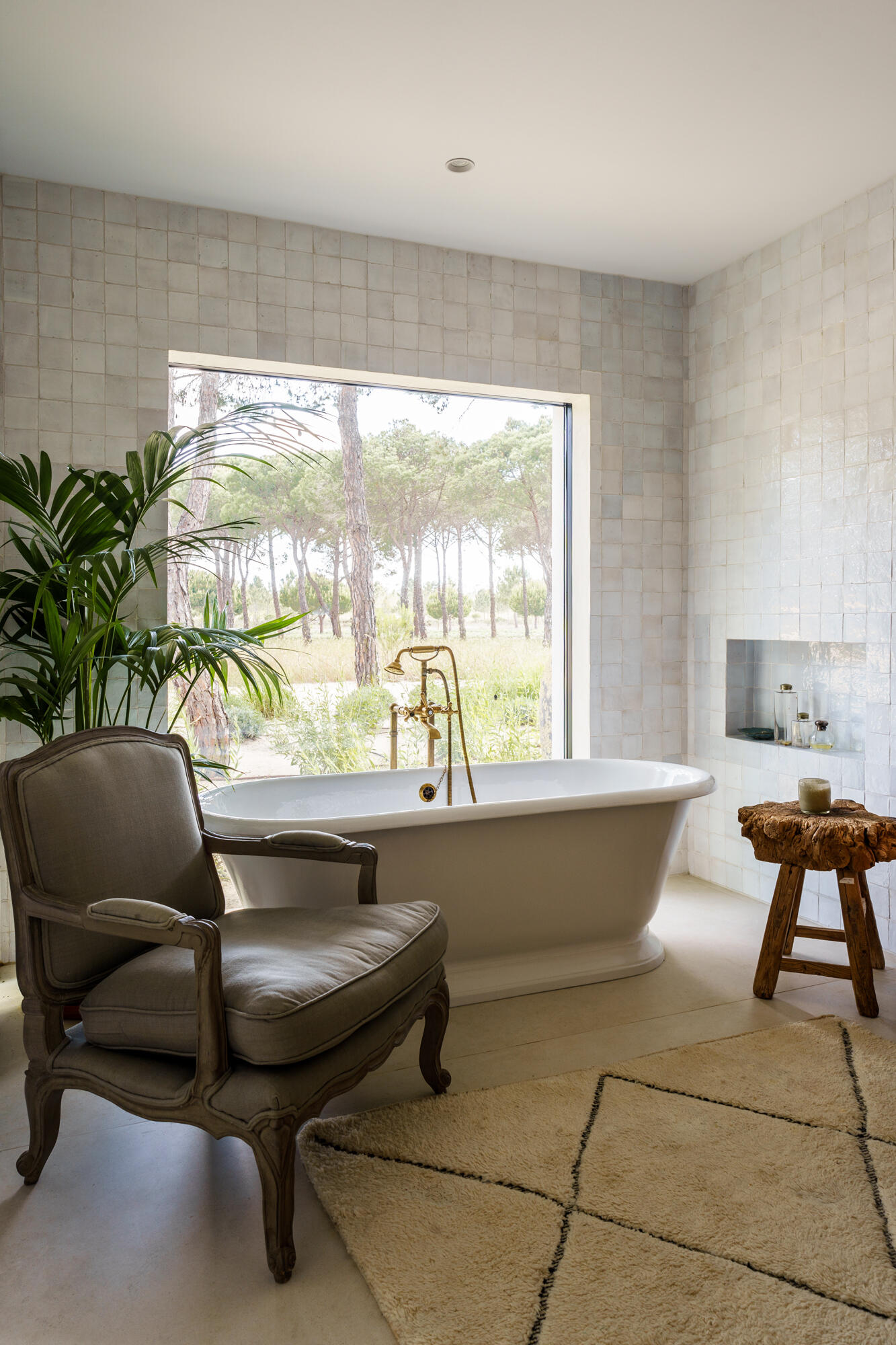 Minimalist bathrooms filled with filtered sunlight and natural textures continue the calm architectural language of this contemporary Portuguese villa.