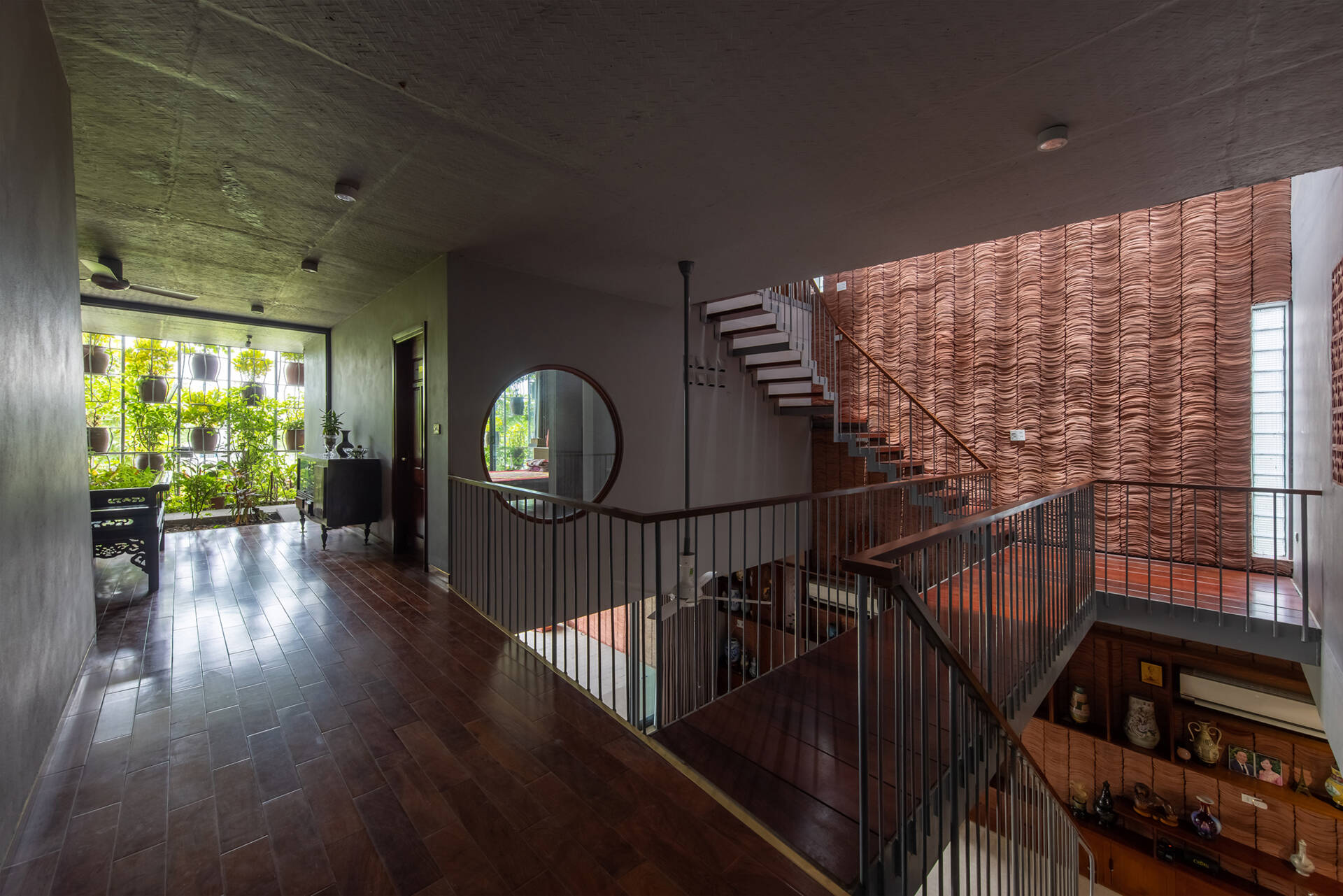 The staircase offers changing views of greenery and light as it connects each level.