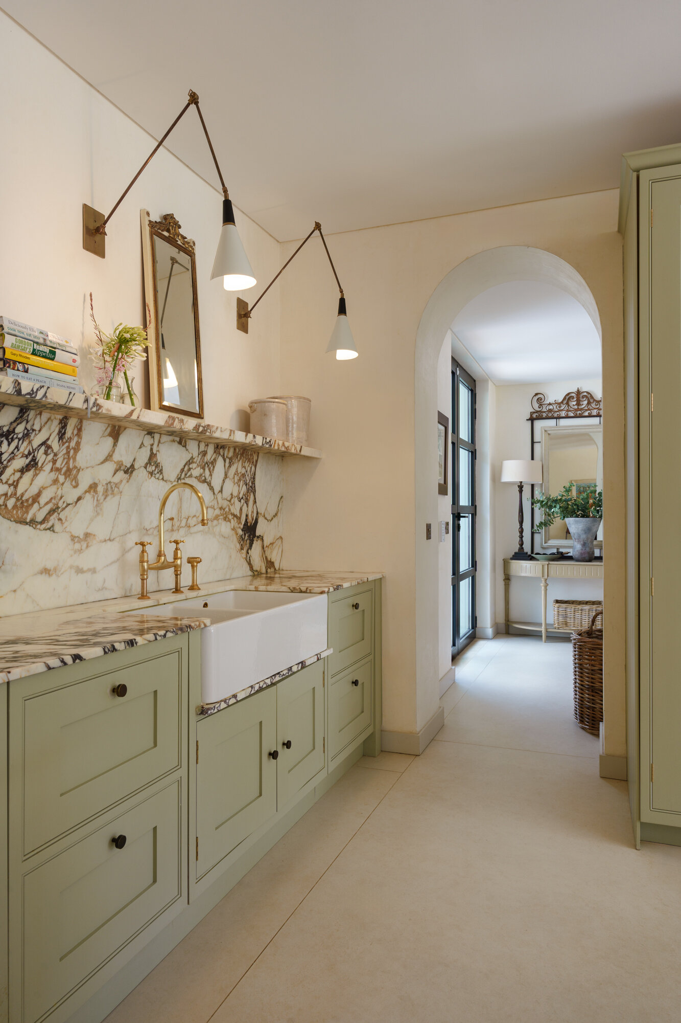 This contemporary kitchen combines sage cabinetry, dramatic marble, woven pendant lights, and a bold plum island for a warm Mediterranean-inspired look.