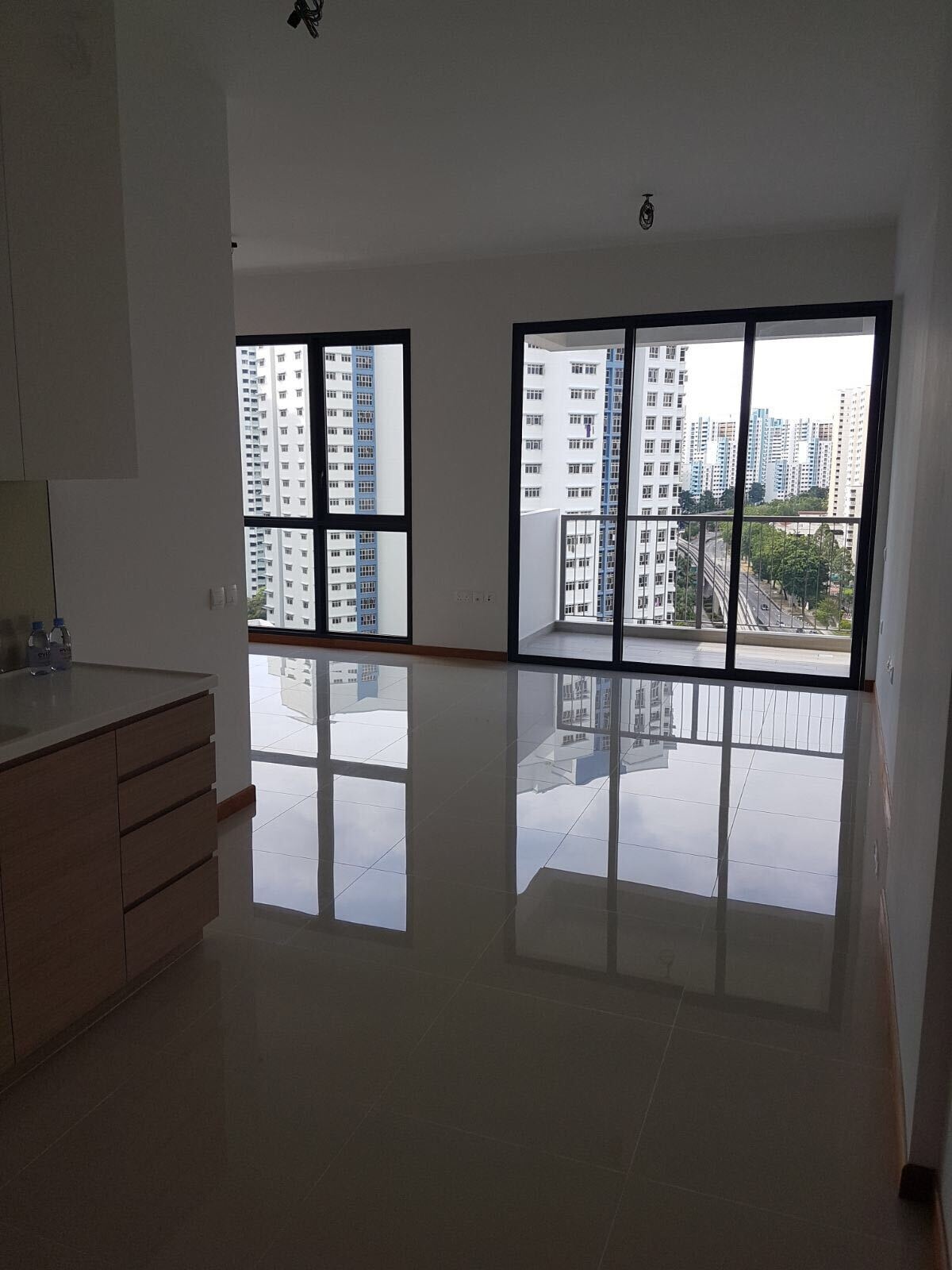 See the before photos of this tiny Singapore studio apartment and how its plain interior became a warm, space-saving home filled with custom design ideas.