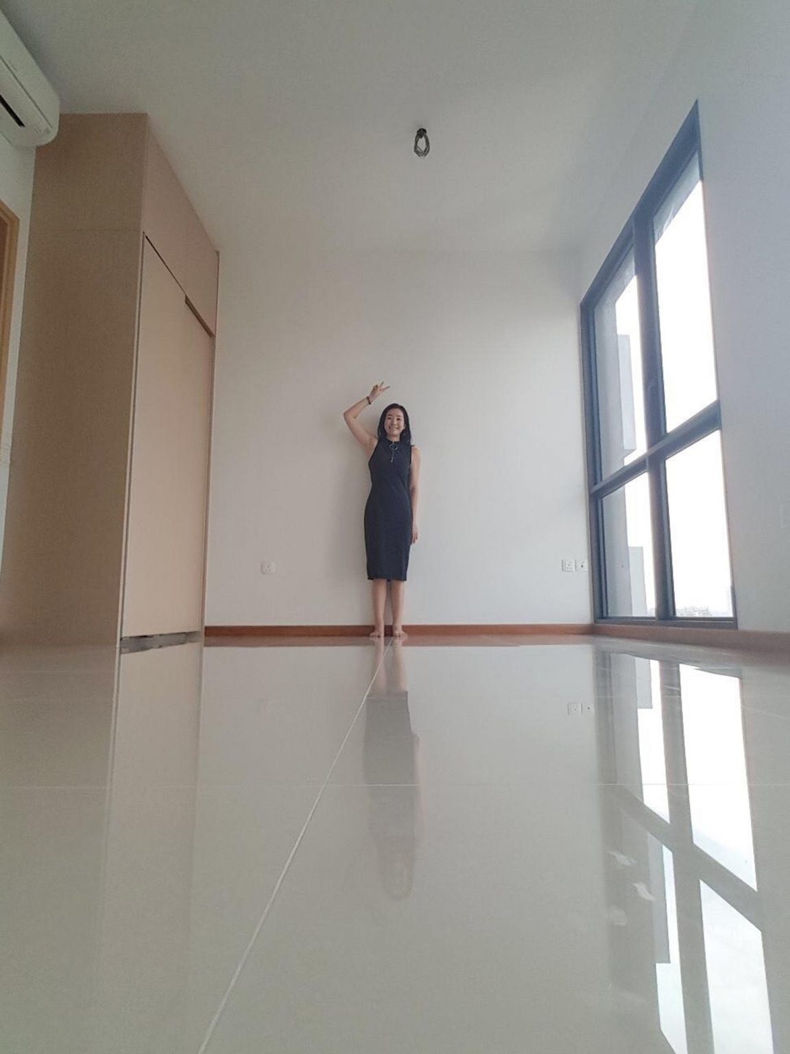 See the before photos of this tiny Singapore studio apartment and how its plain interior became a warm, space-saving home filled with custom design ideas.