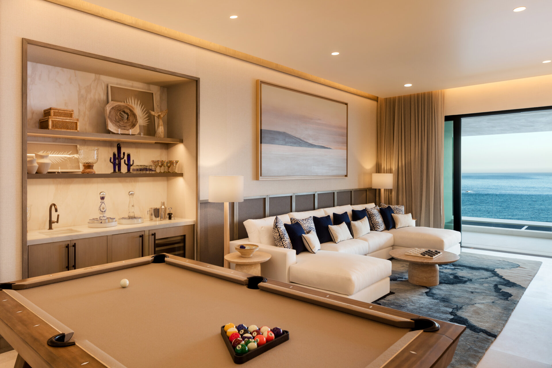 A pool table, bar area, and lounge give this games room an energy that feels active and social instead of overly formal.