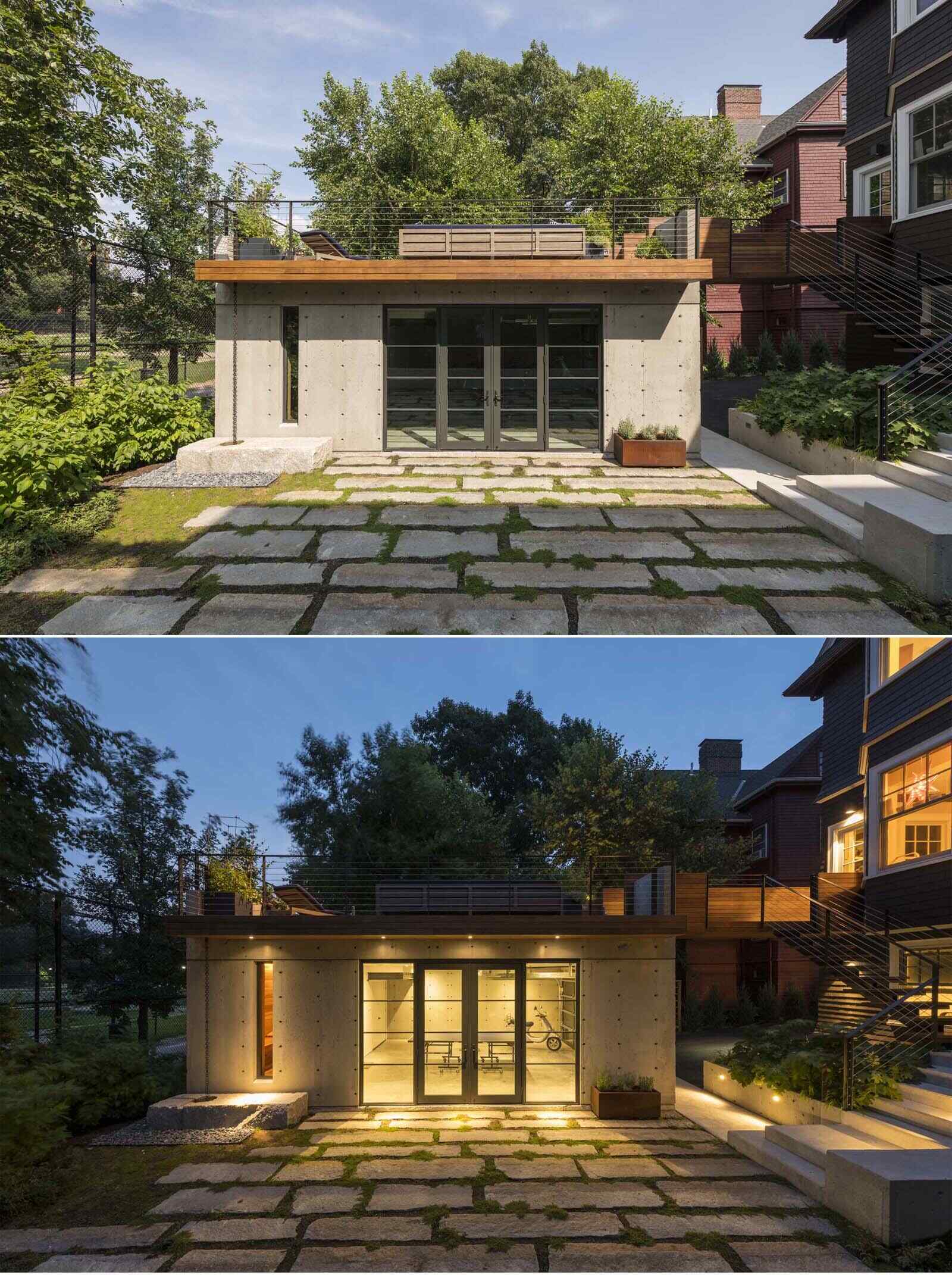 This modern Brookline garage pavilion connects to a Victorian home through a wood bridge and includes entertaining spaces, a sauna, and a rooftop deck.