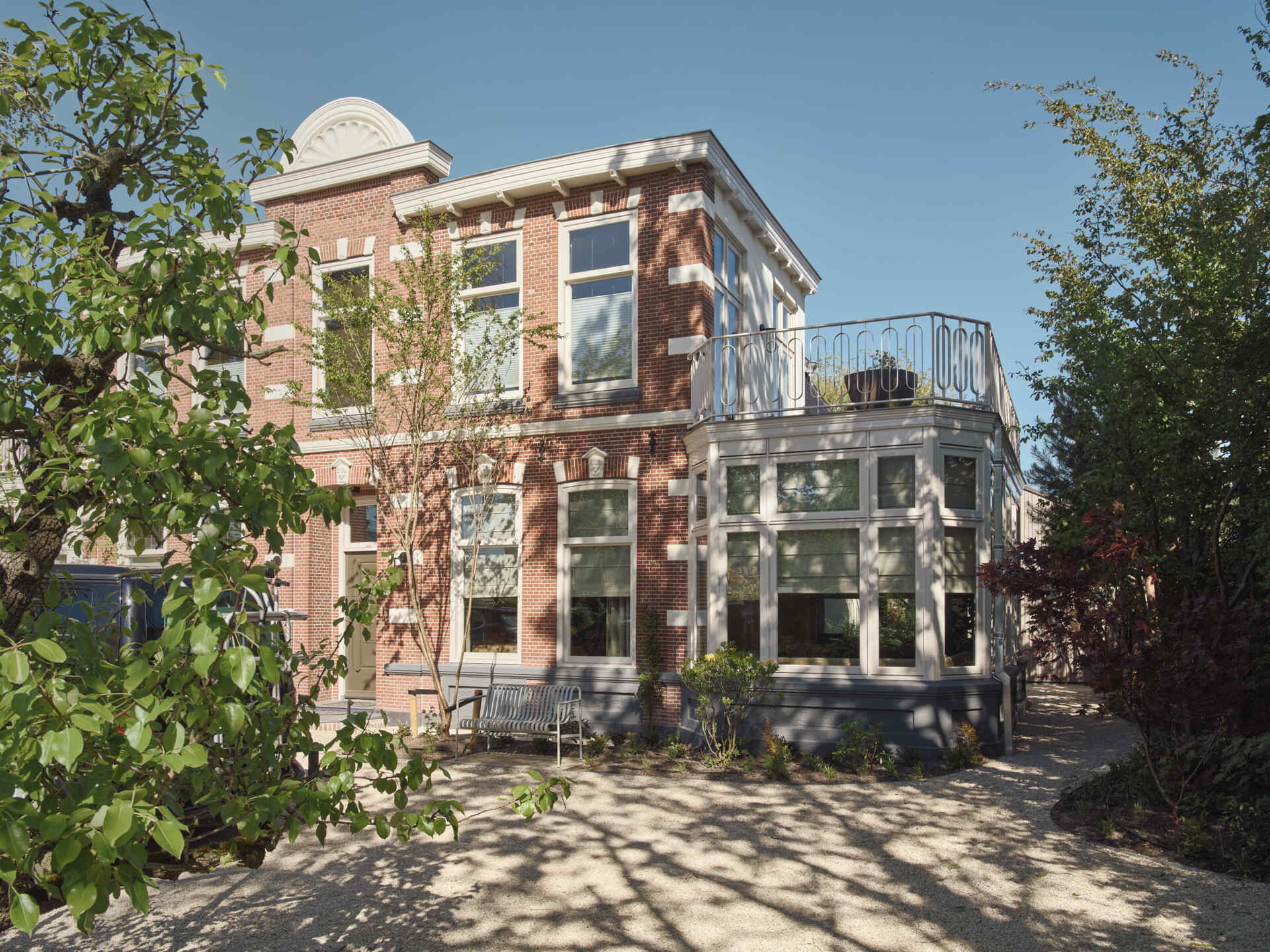 Historic architecture meets modern additions in this Dutch riverside home featuring skylit stairs, layered interiors, and seamless indoor-outdoor flow.