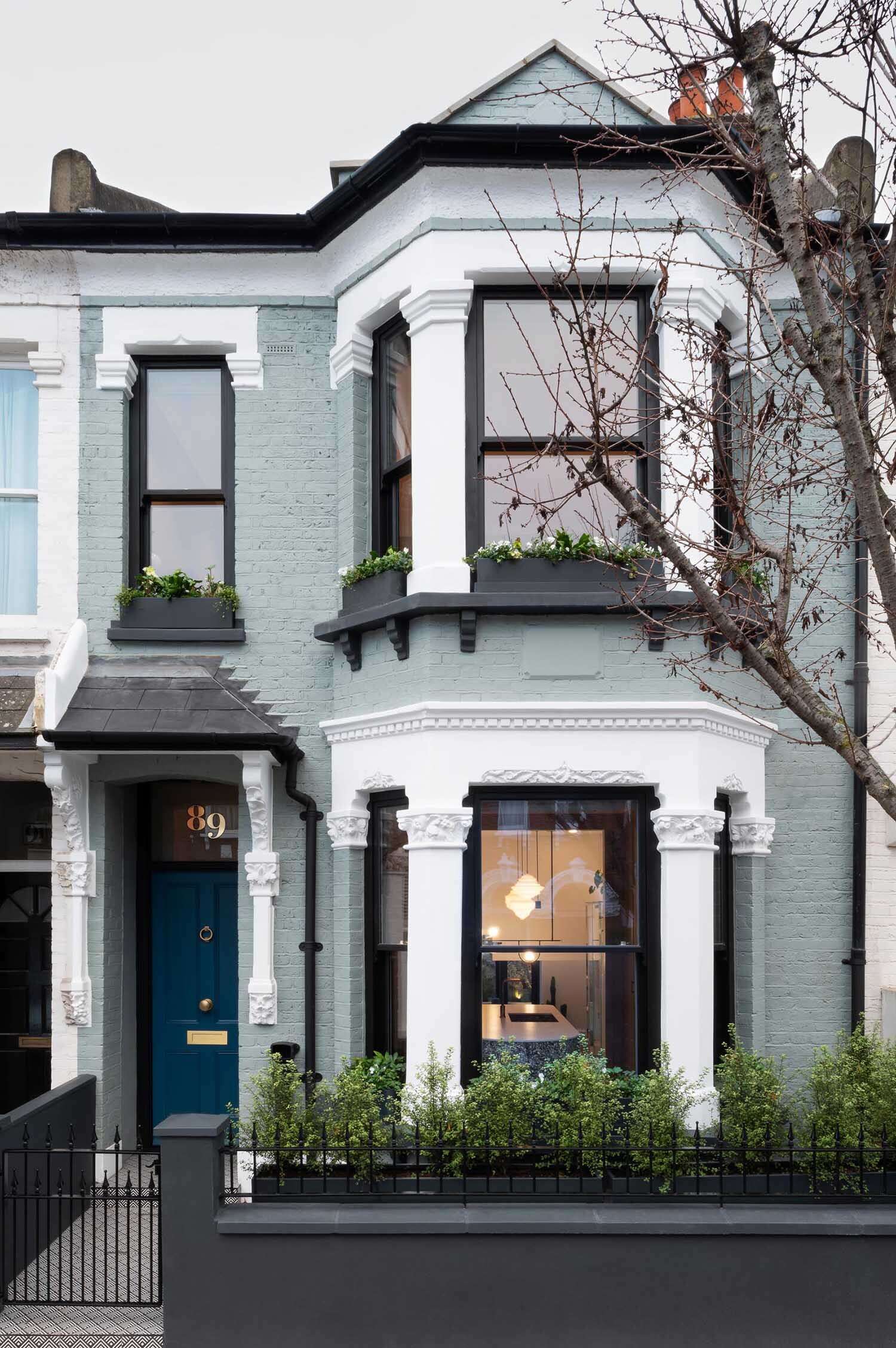 A Victorian terraced house in London transformed with cubist glass volumes, black steel framing, and dramatic geometric forms by Bureau de Change Architects.