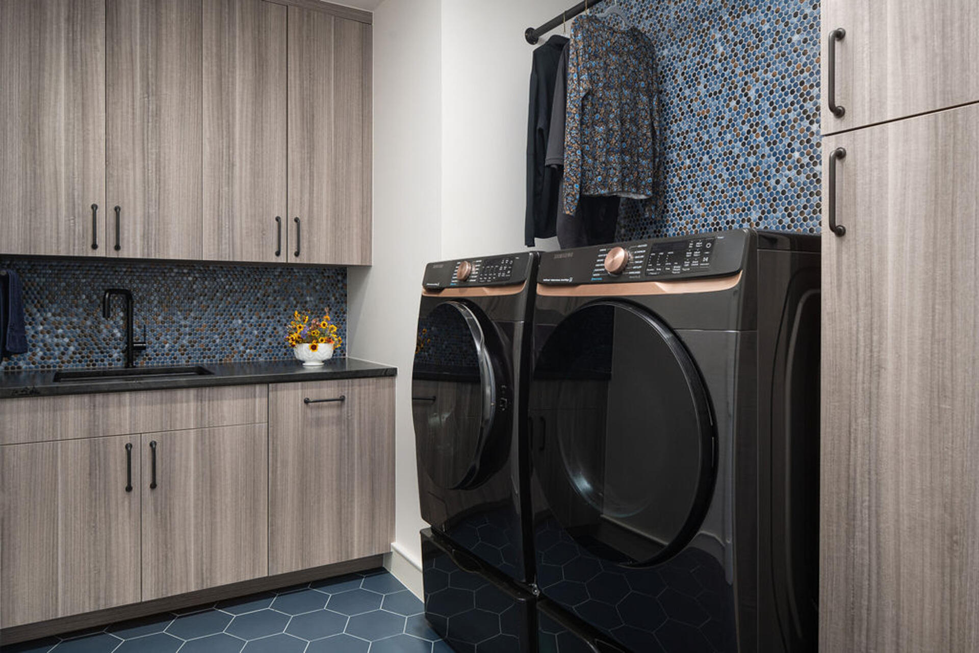 This modern laundry room pairs clean lines and natural materials with bright functional design.