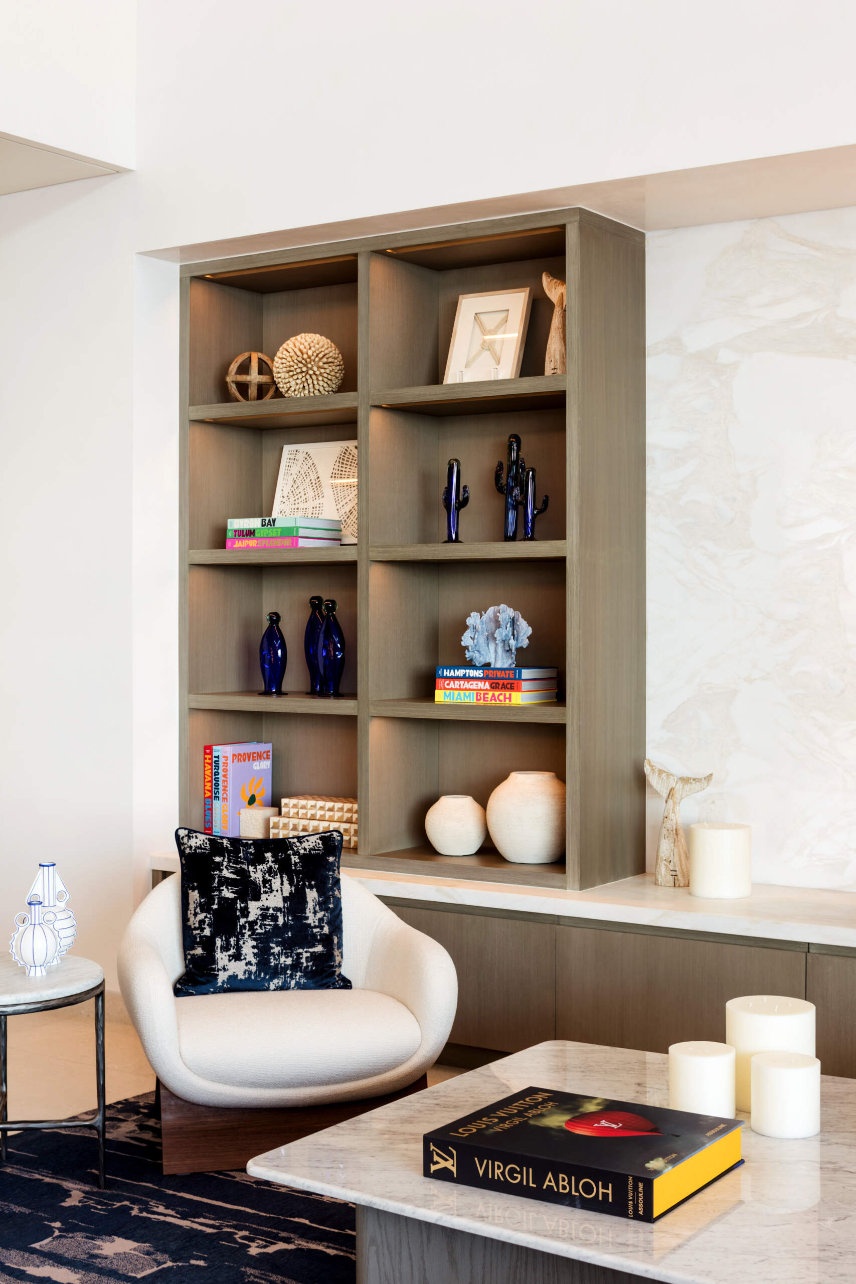 The living room in this Los Cabos condo combines ocean views, layered woods, and relaxed seating designed for family gatherings.