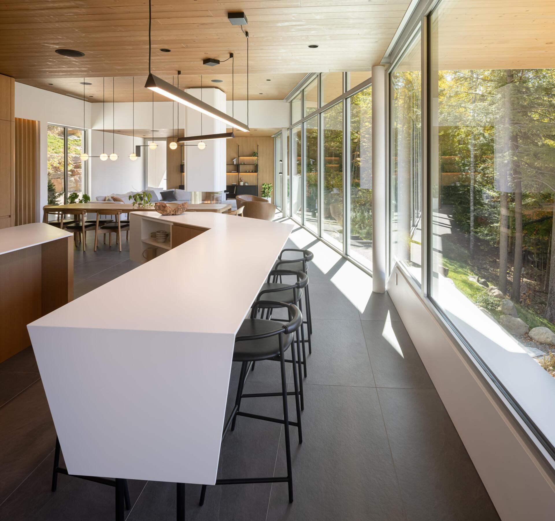 Two sculptural kitchen islands and sunset lake views turn this contemporary Québec kitchen into a standout entertaining space.