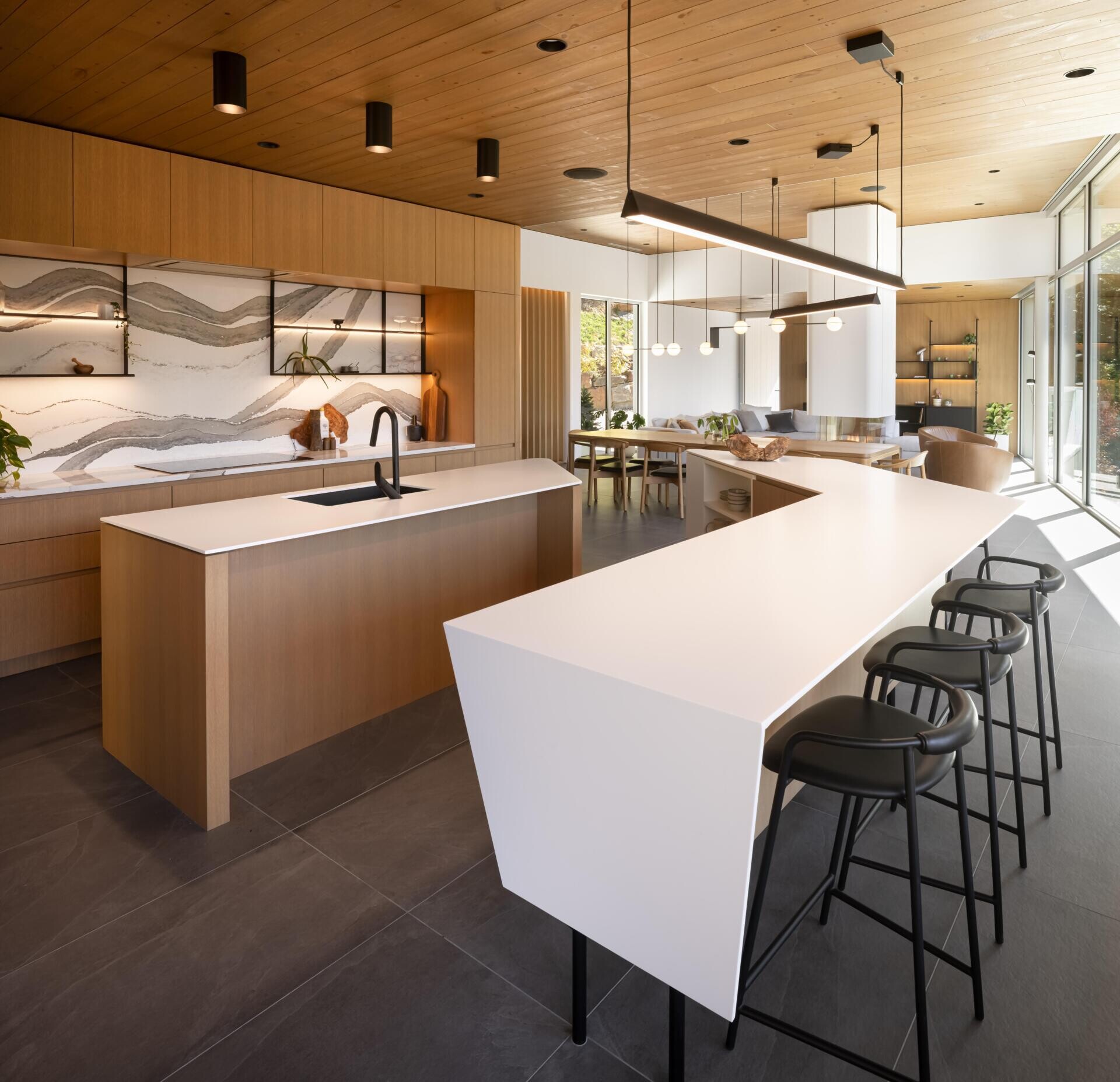 Two sculptural kitchen islands and sunset lake views turn this contemporary Québec kitchen into a standout entertaining space.