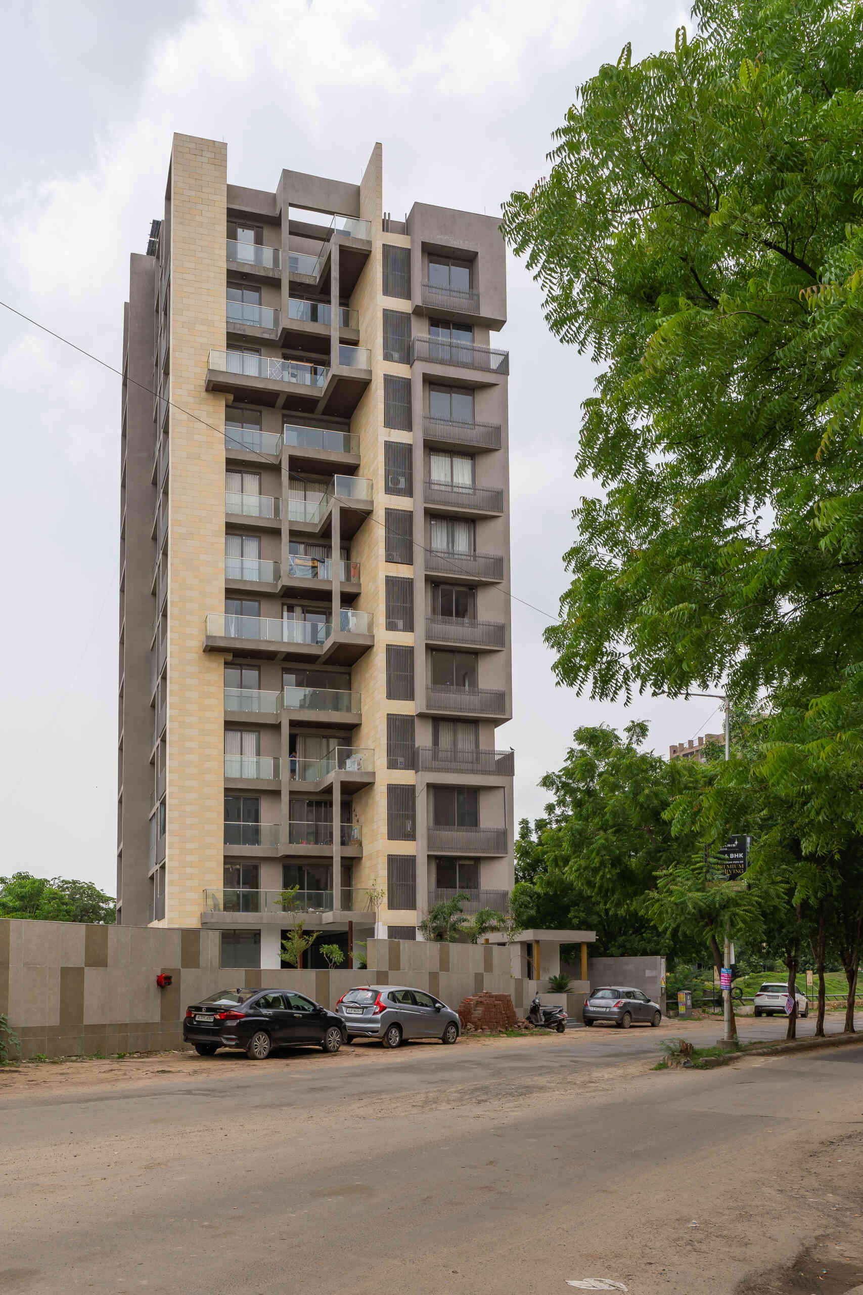 This Ahmedabad apartment building by UA Lab uses staggered balconies and deep overhangs to create a playful facade designed for light, airflow, and shade.
