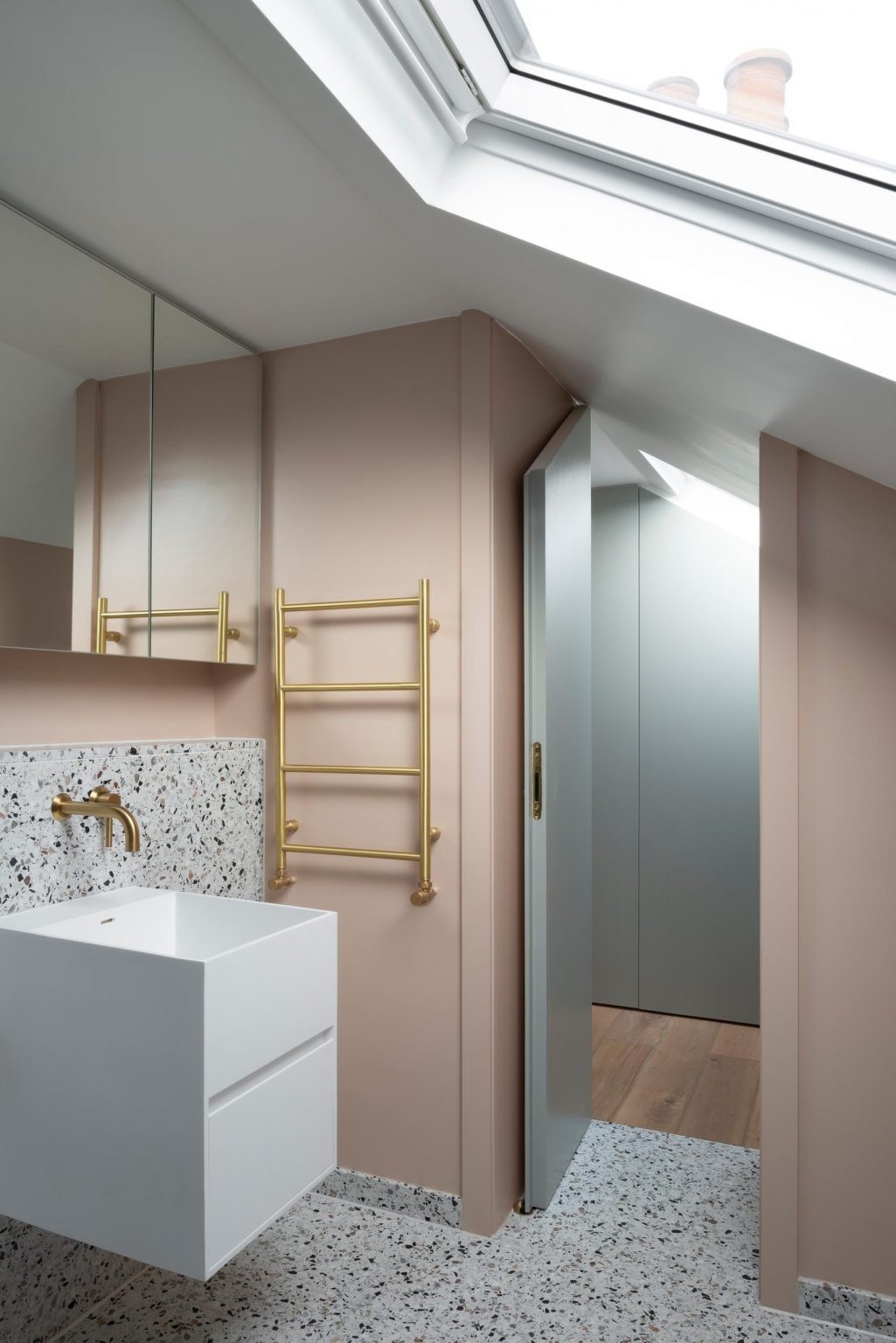 The upper floors of this Victorian London home include a modern main suite with built-in closets, terrazzo details, and minimalist interiors.