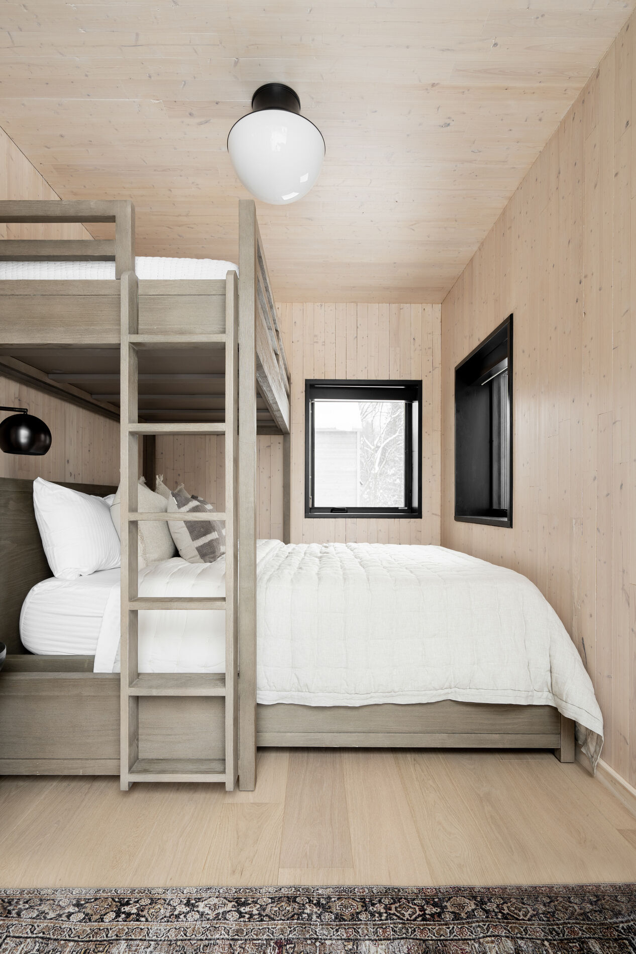 A modern bedroom with bunk beds makes the most of the space.