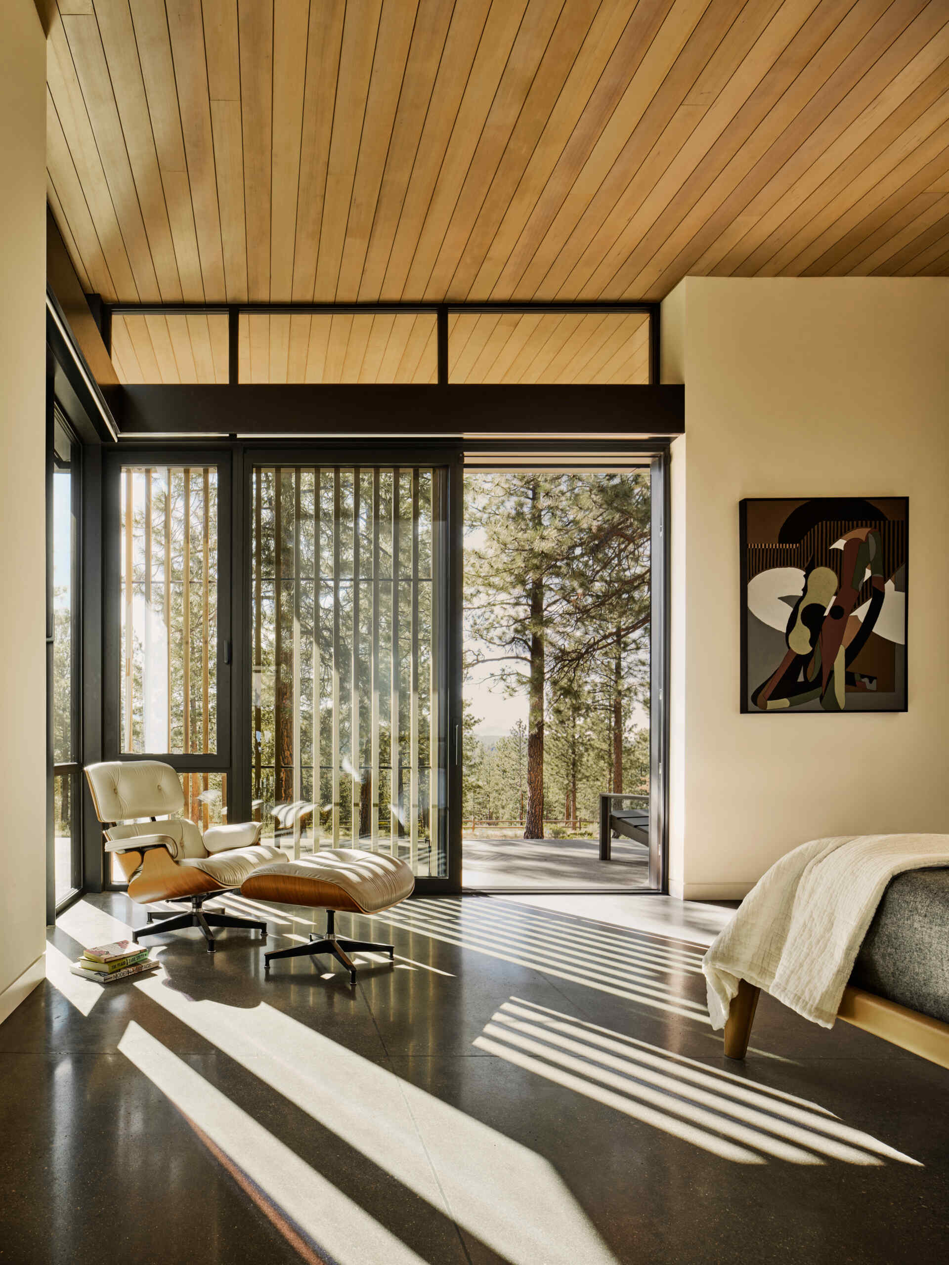 Forest views, private courtyards, and warm minimalist interiors shape the peaceful bedrooms inside this modern Oregon home.