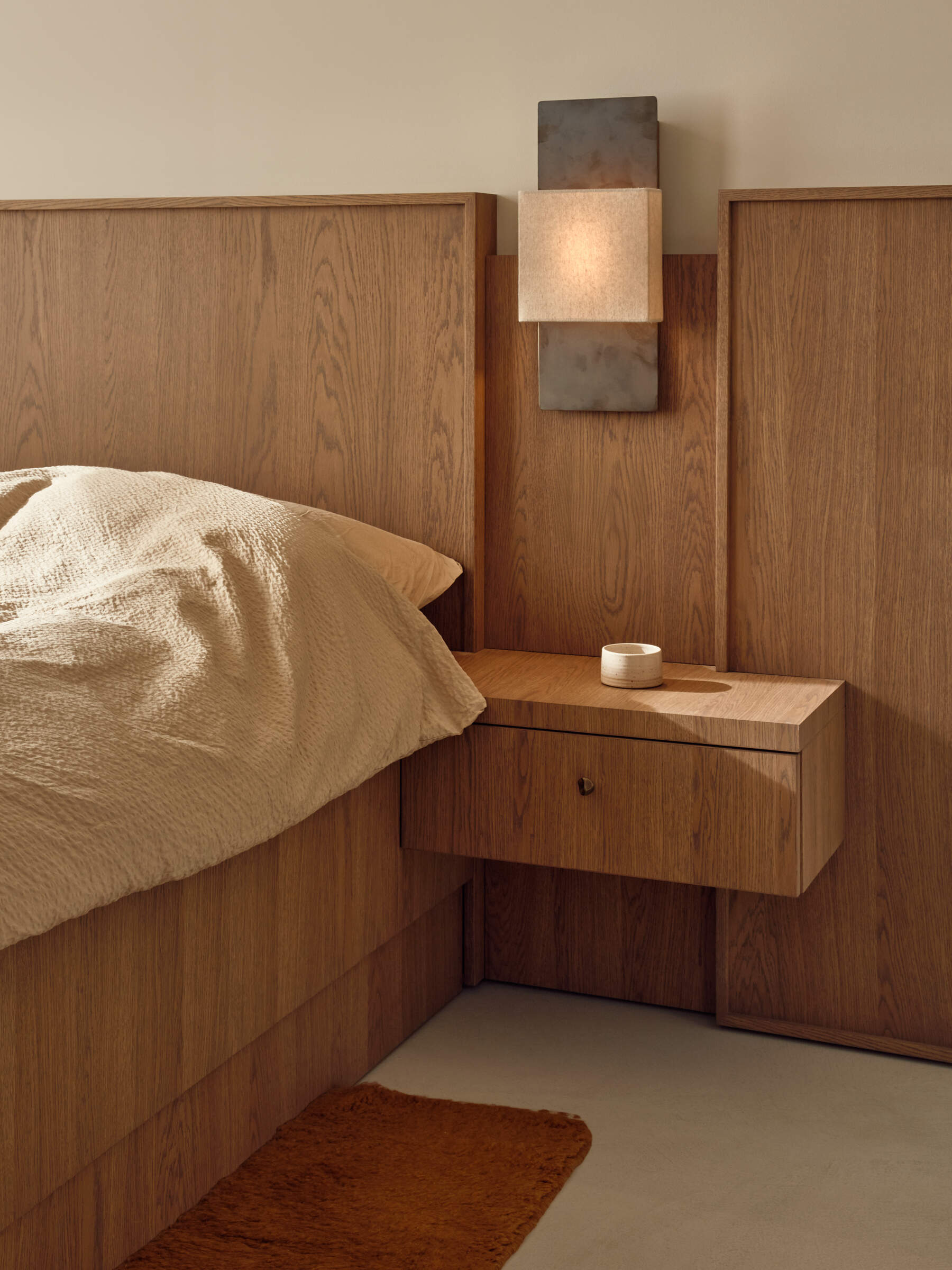 Soft textures, custom bedheads, hidden wardrobes, and warm wood finishes define this calming modern bedroom.