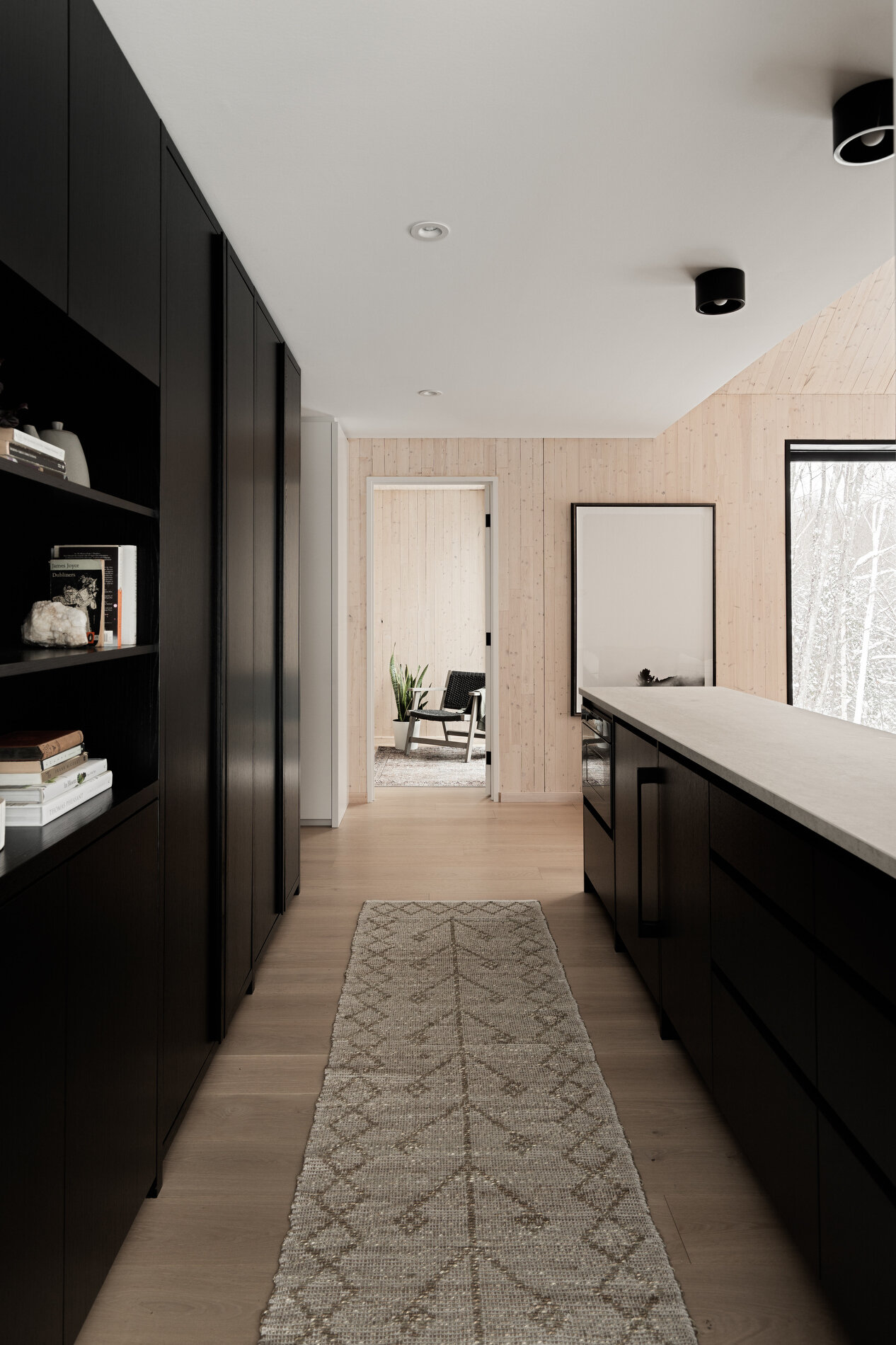 A modern kitchenette with black cabinets.