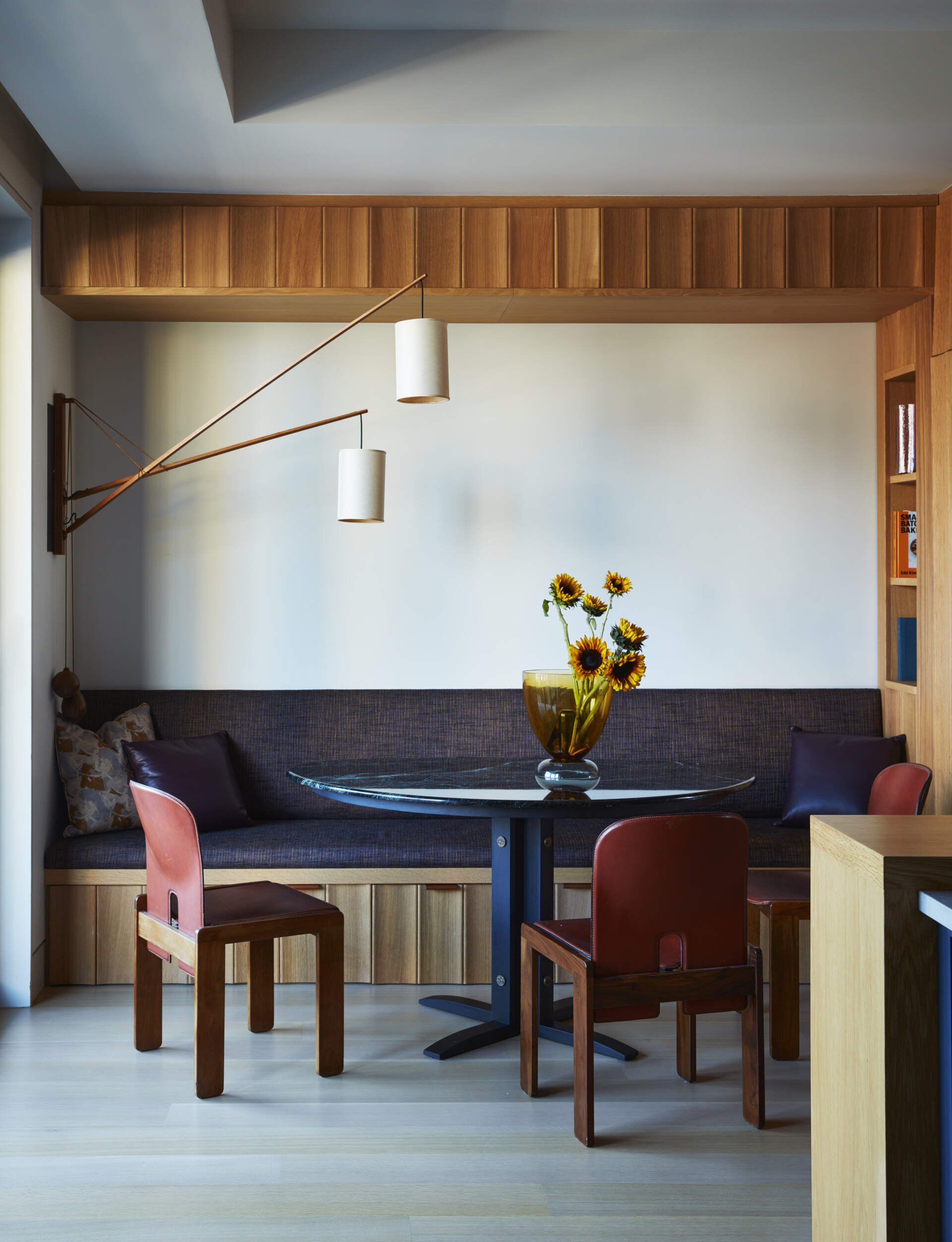 A custom marble breakfast table and banquette seating bring warmth and comfort to this stylish family loft.