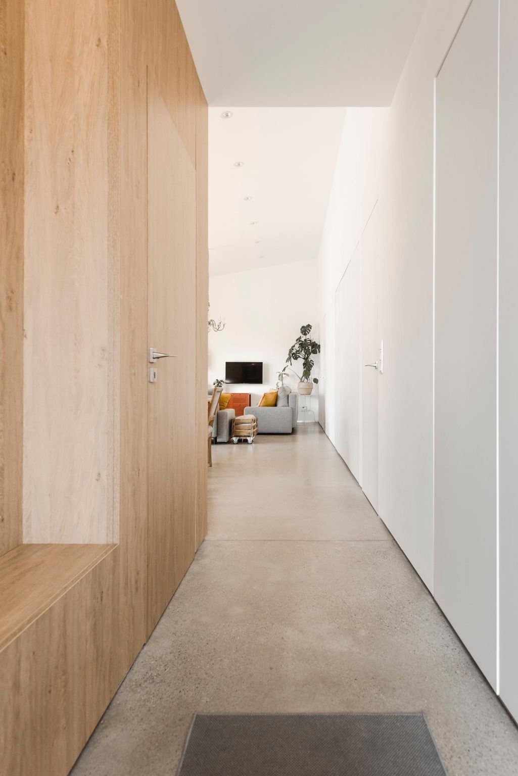 This compact 110-square-metre home uses hidden storage, flush doors, and open-plan living to create a highly functional family layout.