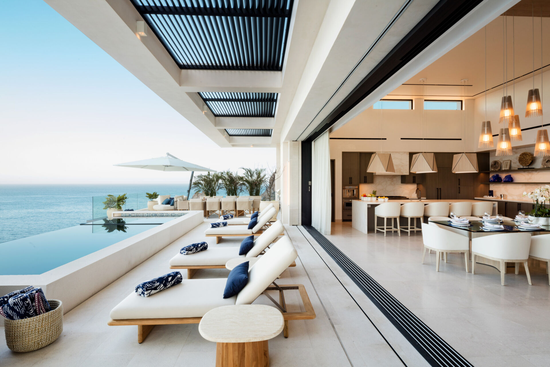 A luxury condo in Los Cabos by Louis Ruiz focuses on family gatherings, eclectic interiors, sculptural lighting, and warm indoor-outdoor living with incredible ocean views.