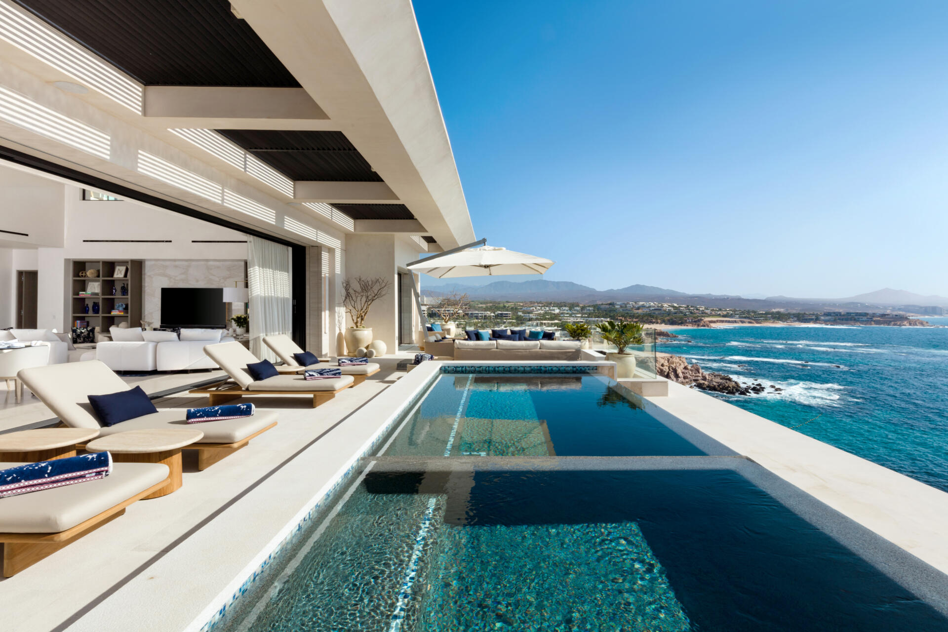 An infinity pool, outdoor dining, and expansive oceanfront lounges define this incredible Los Cabos patio design.