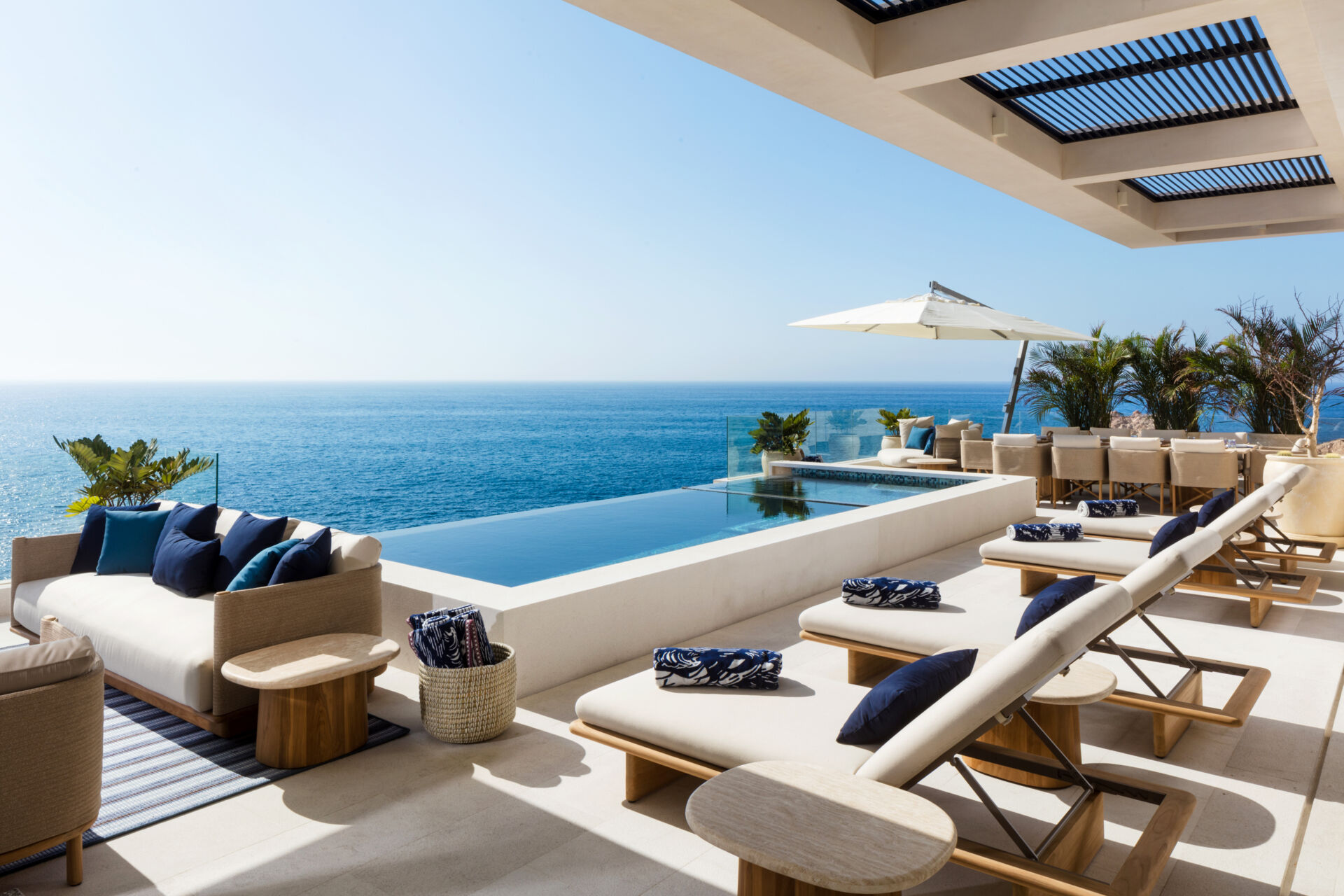 An infinity pool, outdoor dining, and expansive oceanfront lounges define this incredible Los Cabos patio design.
