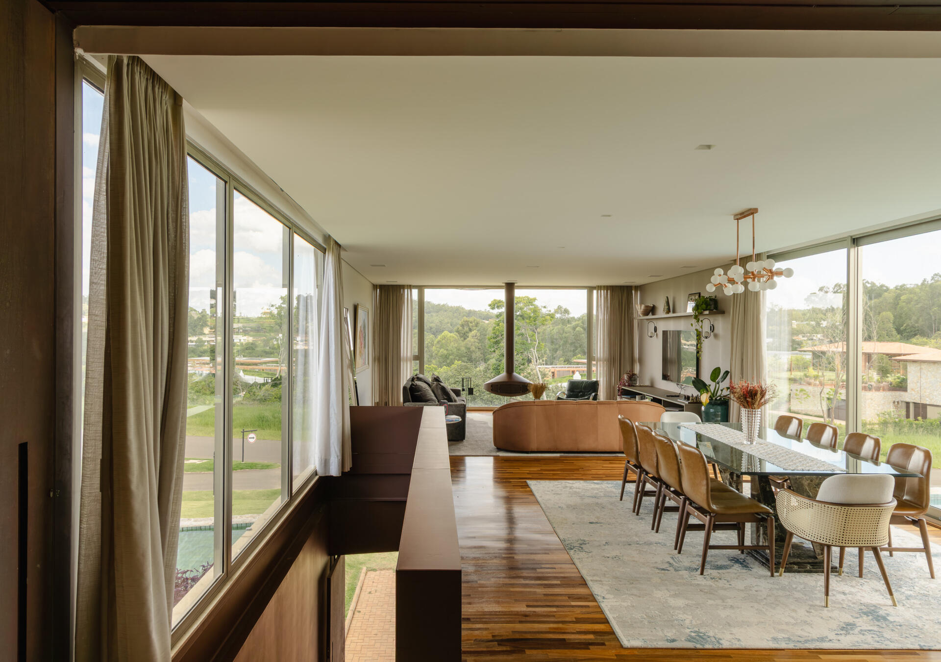 Casa Themis uses an L-shaped layout to connect dining spaces, lounges, and outdoor terraces, creating a home designed for entertaining and relaxed weekends.