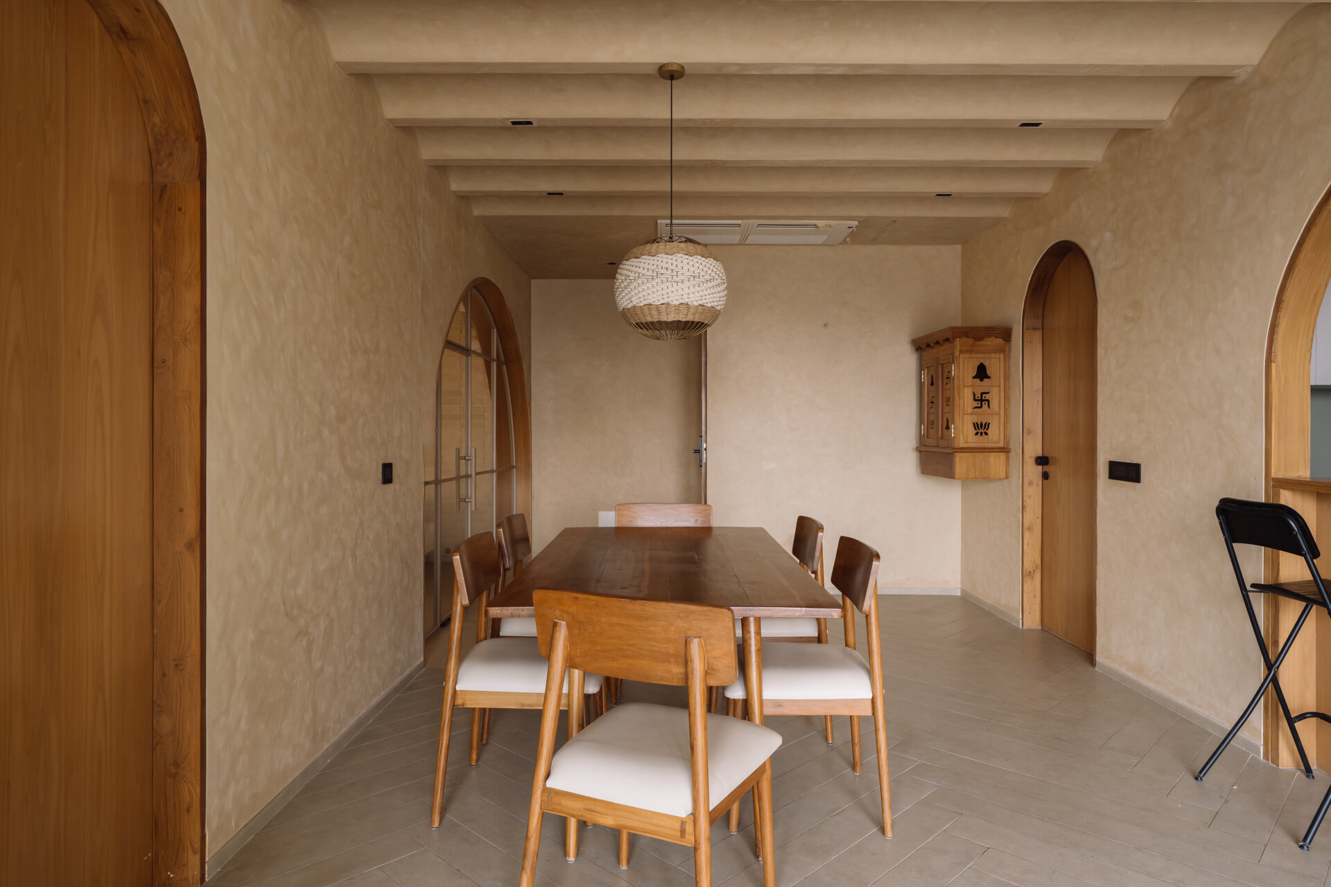 An open plan dining room features arches that lead to other rooms, like the living room.