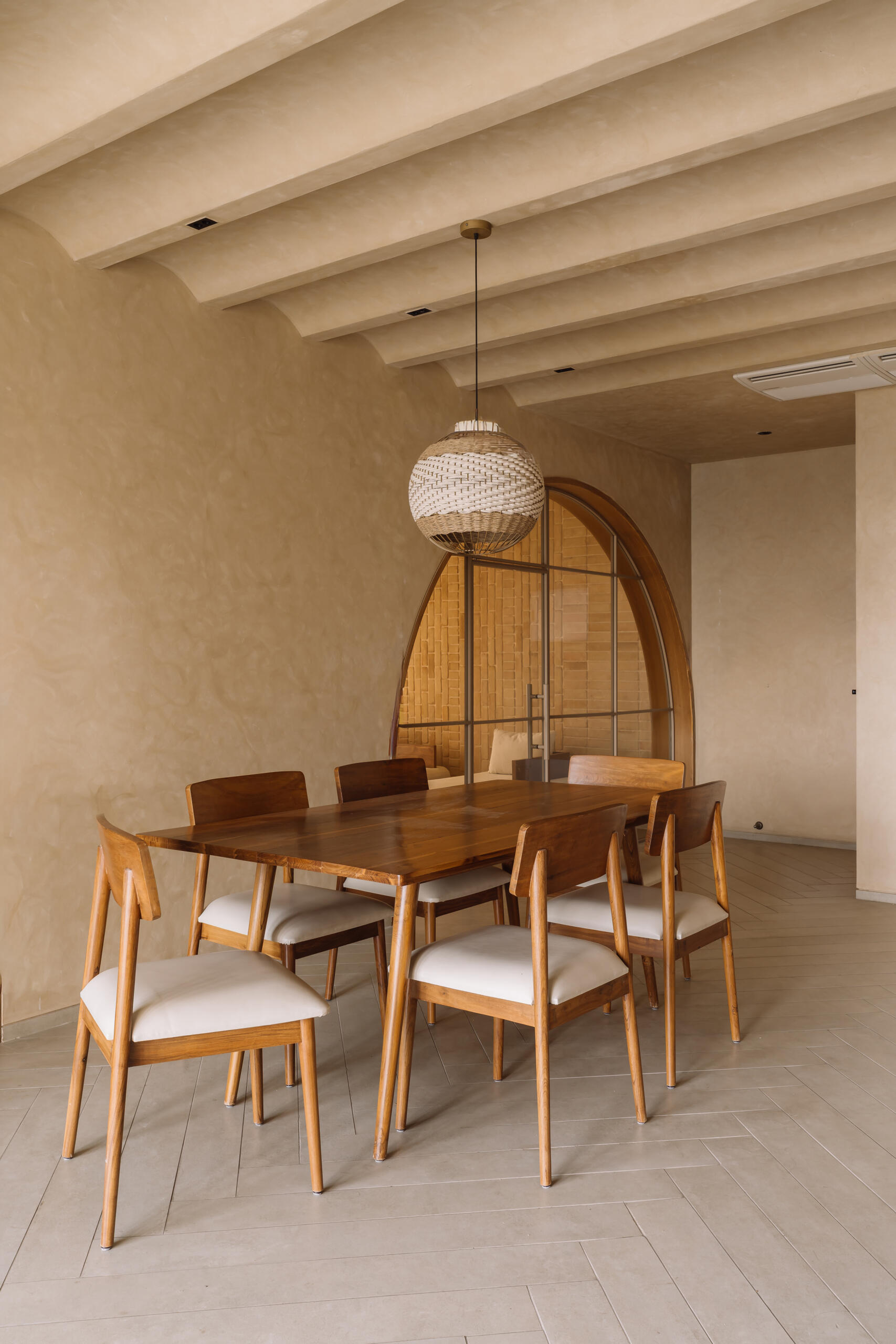 An open plan dining room features arches that lead to other rooms, like the living room.