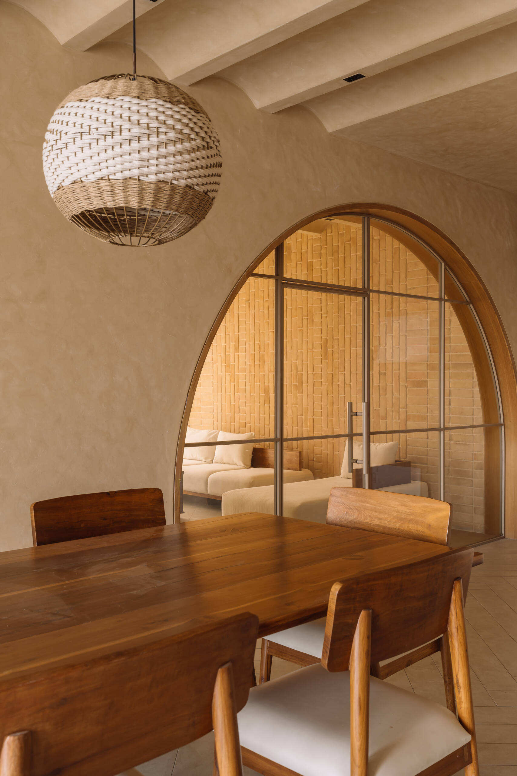 An open plan dining room features arches that lead to other rooms, like the living room.