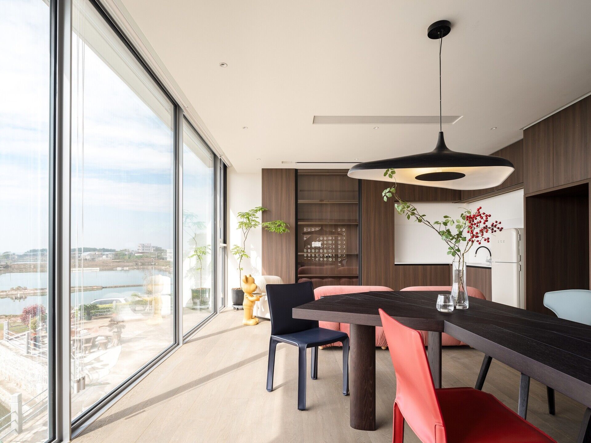 A modern dining room with angular wood table.