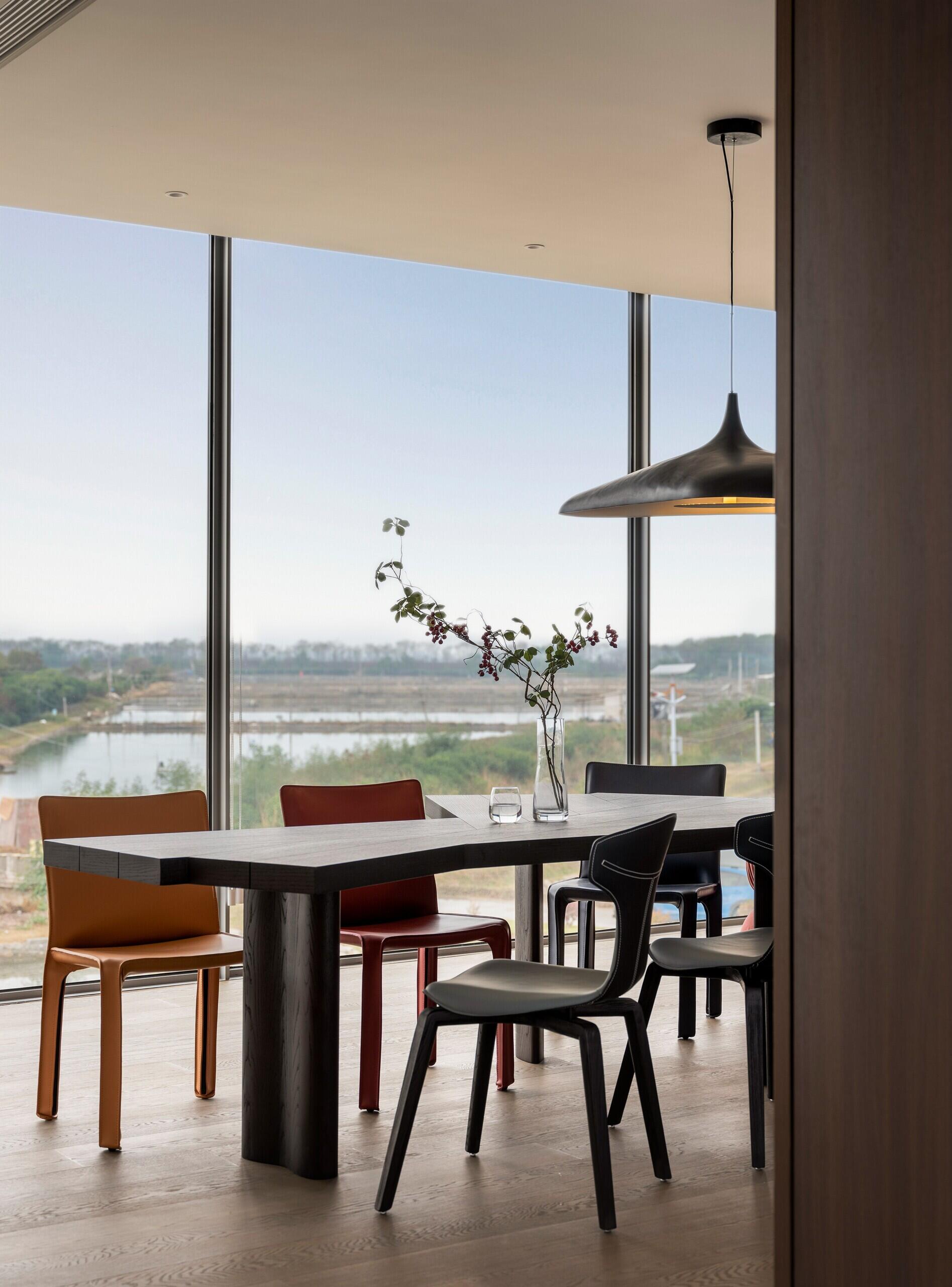 A modern dining room with angular wood table.