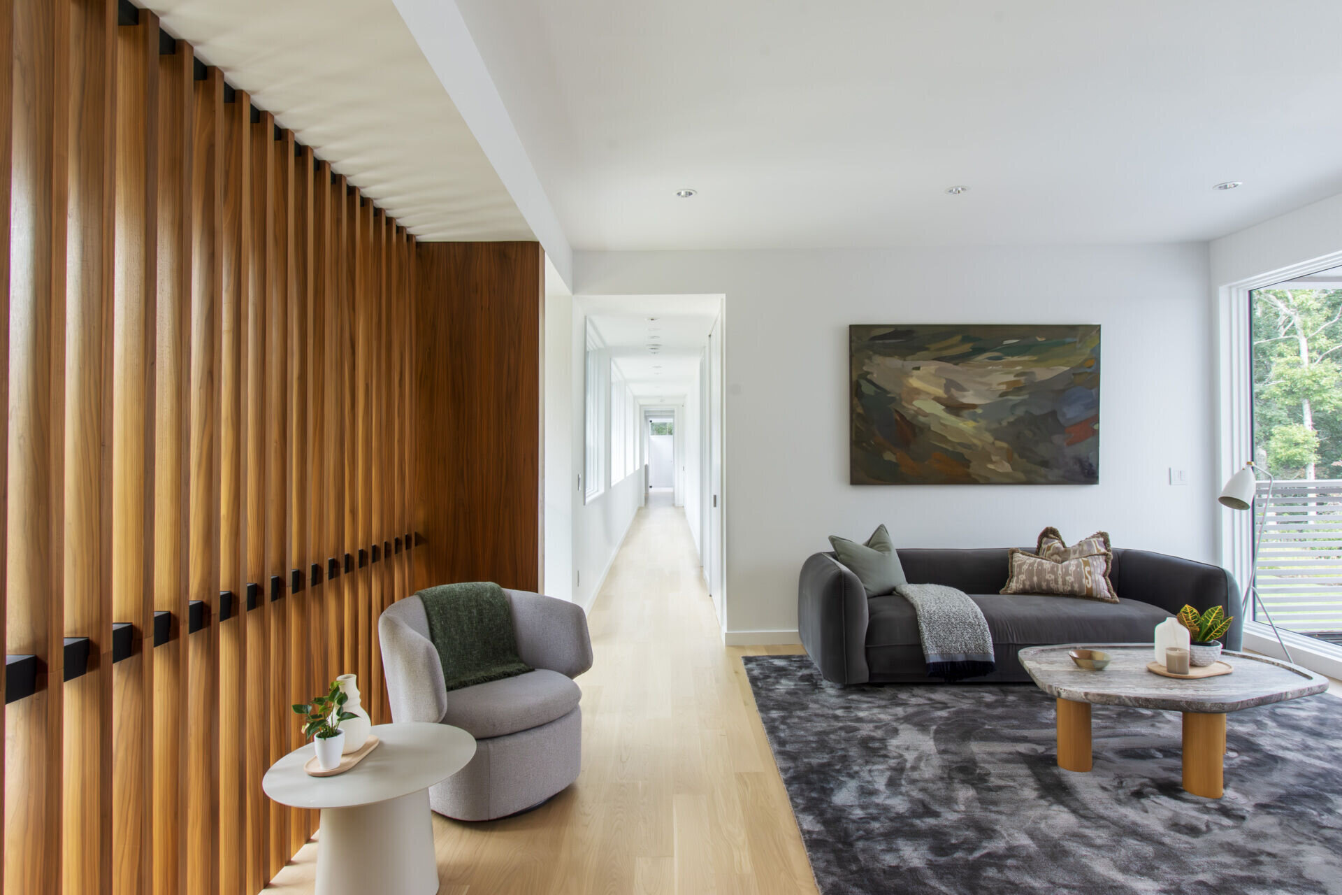 An adaptable upstairs lounge offers elevated woodland views and flexible family living space.
