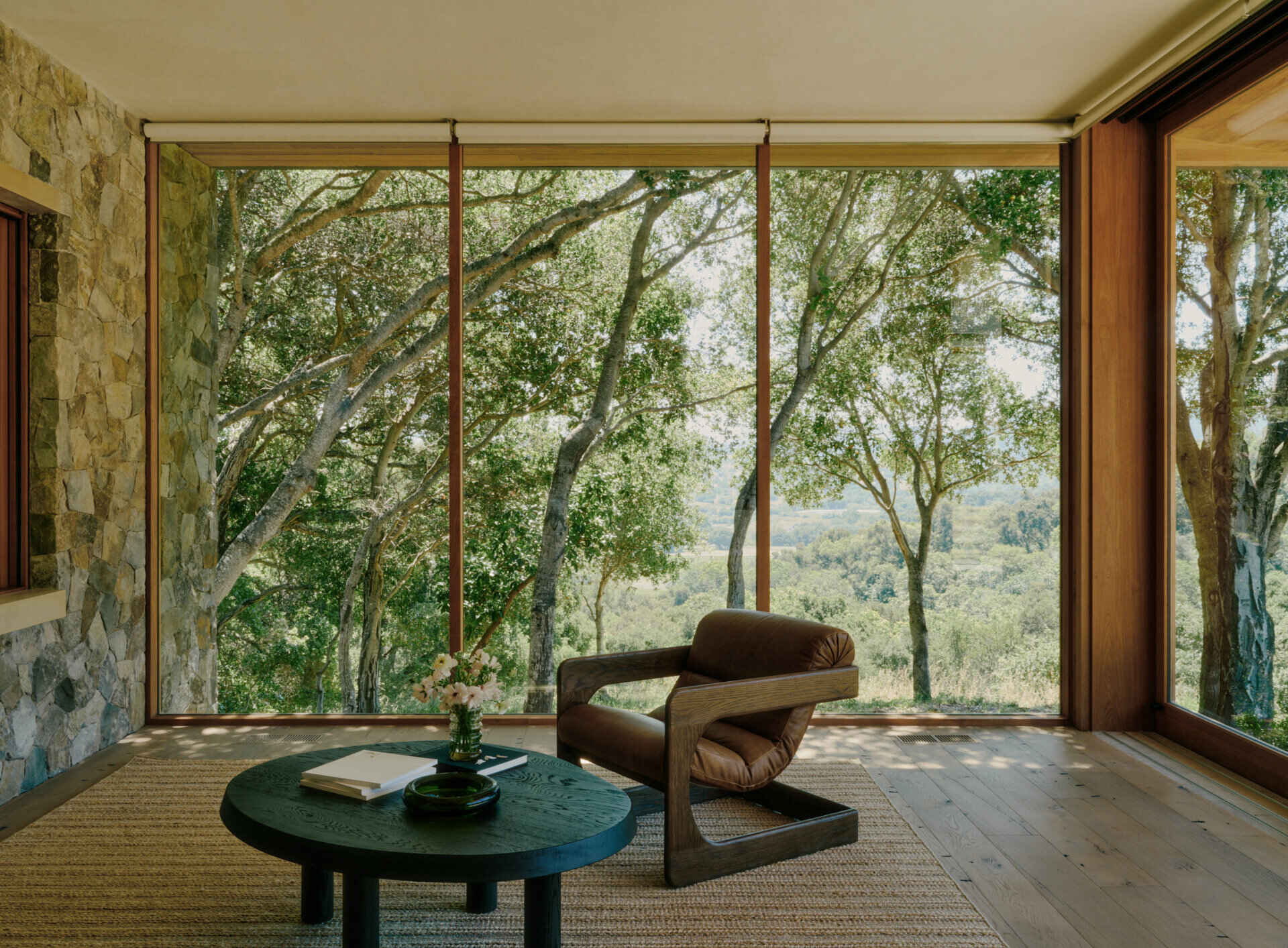 A detached guest suite beside the pool gives visitors privacy while maintaining the warm modern design of the main villa.