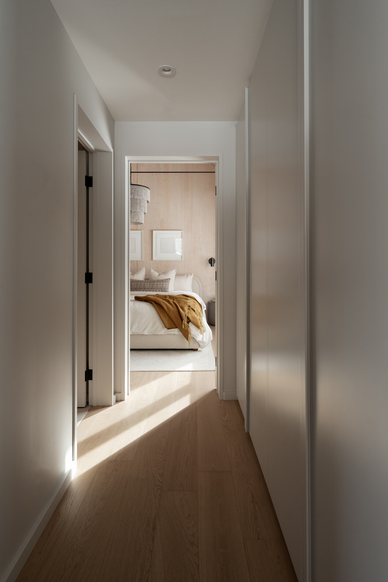 A modern mountain cabin inspired bedroom with wood walls and a built-in desk.
