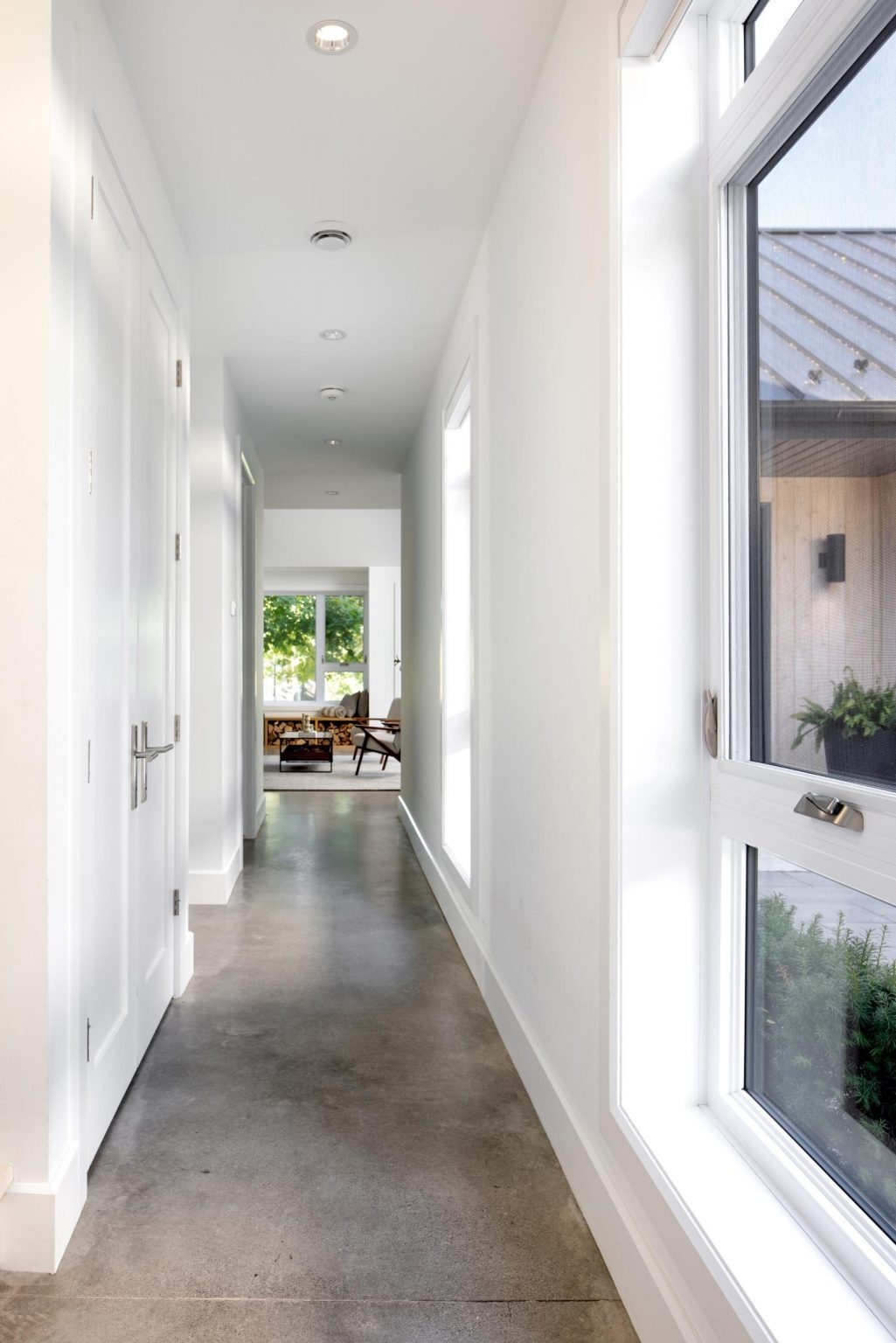 Polished concrete floors run throughout this modern Windsor home, creating a clean, minimal look that connects every interior space.