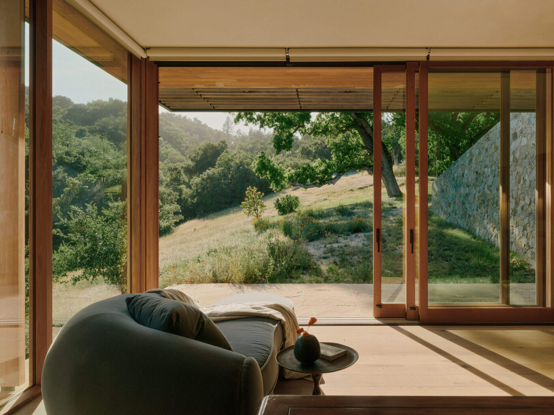 A private office pavilion overlooks the California landscape with warm materials, natural light, and framed hillside views.