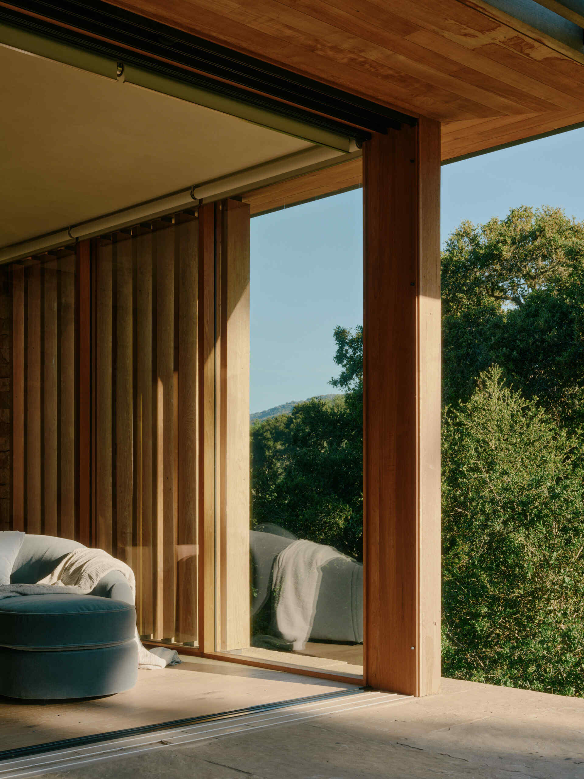 A private office pavilion overlooks the California landscape with warm materials, natural light, and framed hillside views.