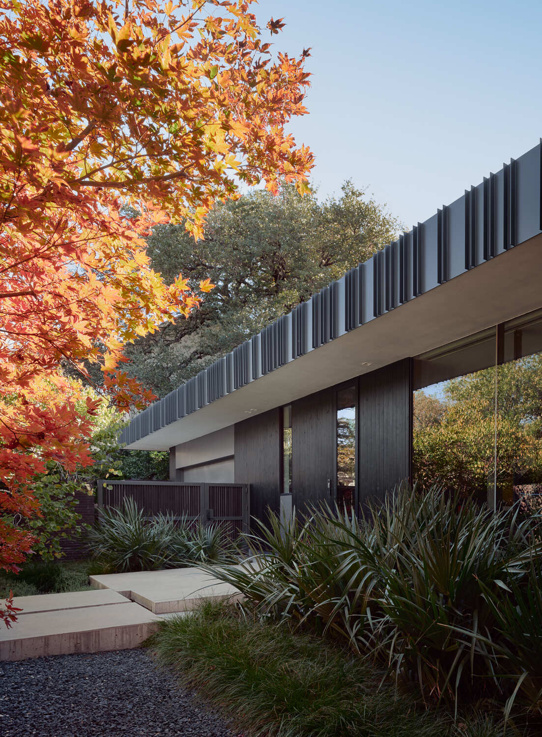 Tour the bold exterior of Tarrytown Residence, where black brick, ebony-stained cedar, custom steel detailing, and expansive glass walls create a contemporary architectural statement in Austin, Texas.