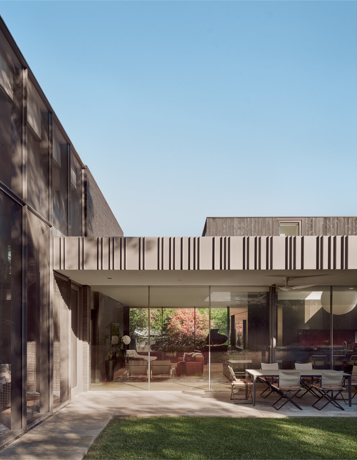Tour the bold exterior of Tarrytown Residence, where black brick, ebony-stained cedar, custom steel detailing, and expansive glass walls create a contemporary architectural statement in Austin, Texas.