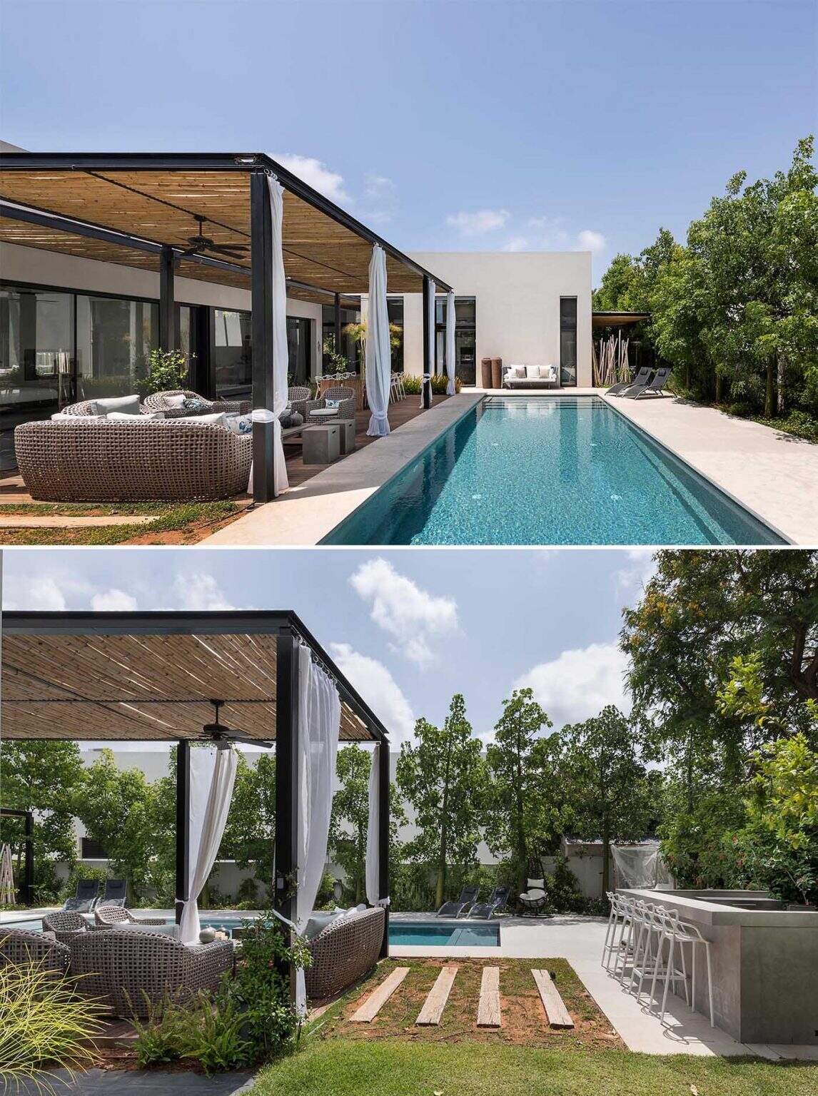 A bamboo pergola with white curtains creates a stylish poolside outdoor living and dining area beside this modern home.