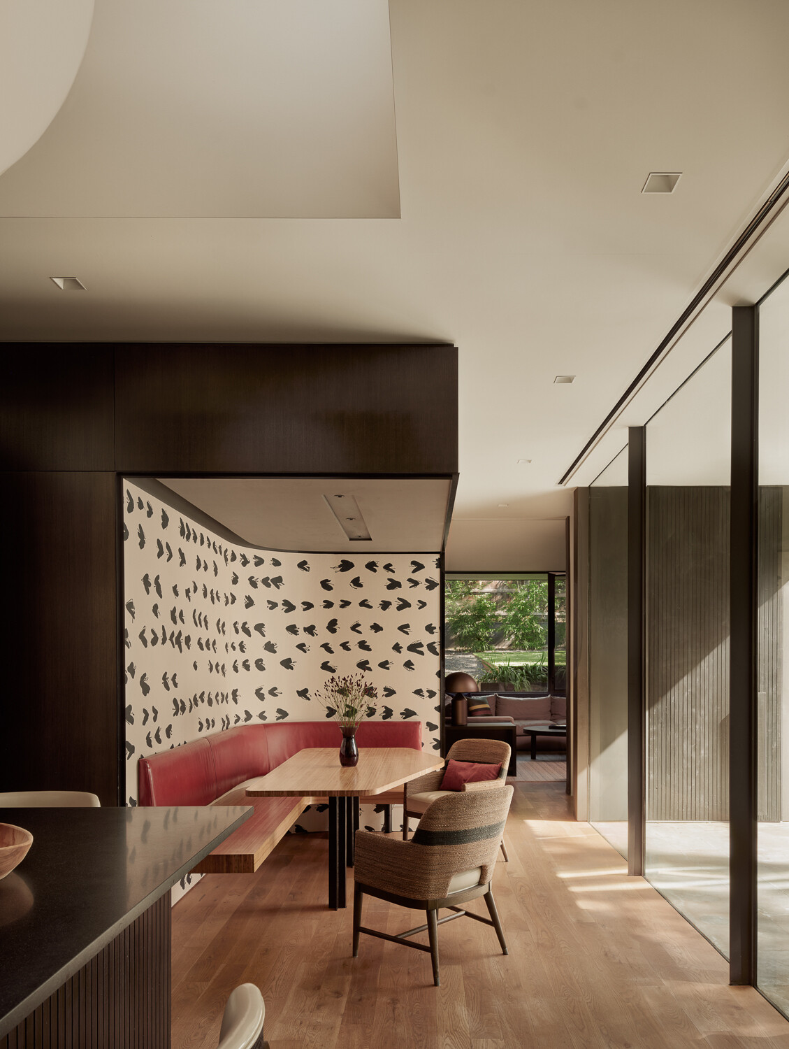 This bright breakfast nook captures natural light and courtyard views, creating a relaxed gathering spot that feels connected to both the home's interiors and outdoor spaces.
