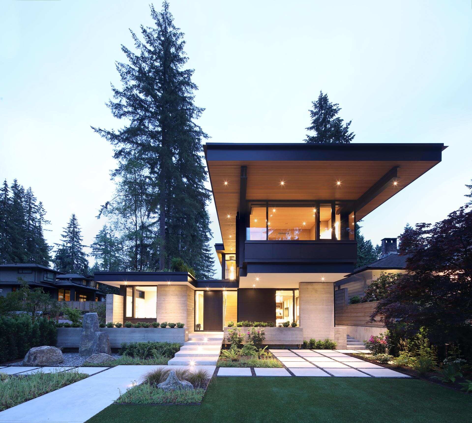 A striking modern home in North Vancouver blends wood, steel, concrete, and black architectural details with warm West Coast design influences.