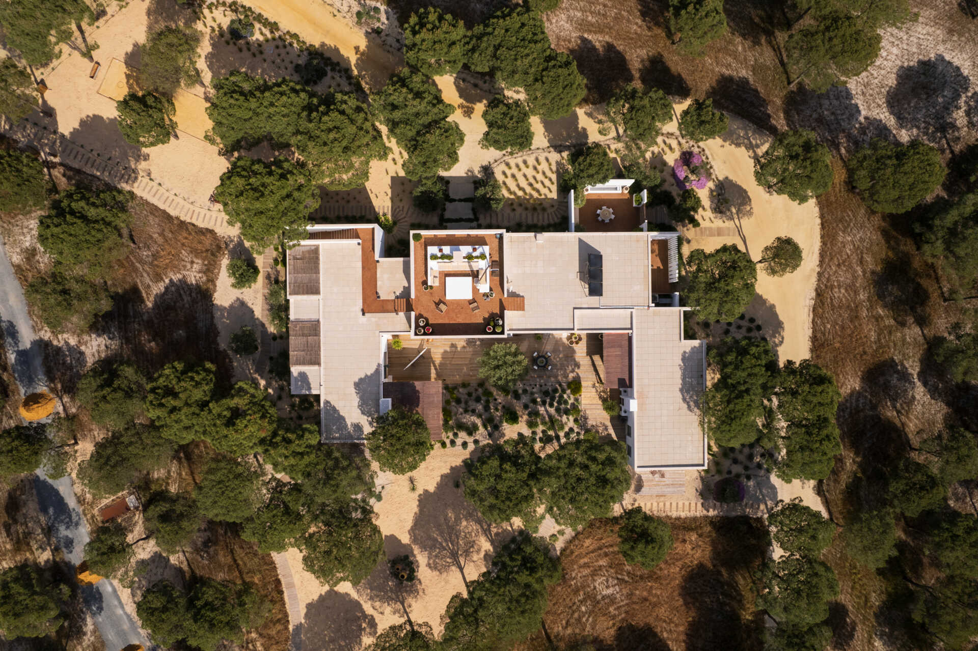 This contemporary villa in Comporta, Portugal by SabraB Architecture pairs crisp white architecture with pine forests, cork oaks, and minimalist interiors for a stunning indoor-outdoor living experience.