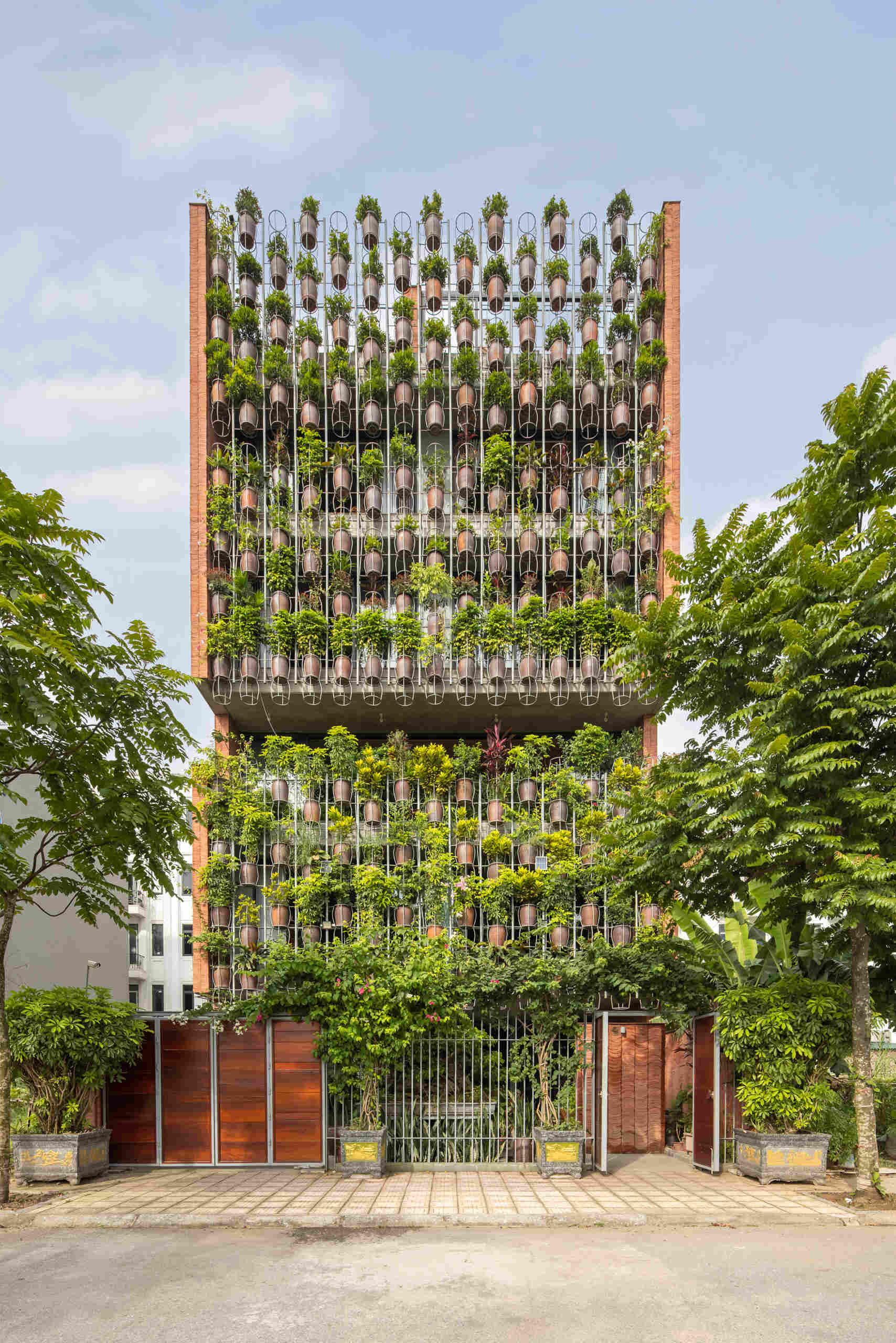 This Vietnamese house uses a layered layout and shared spaces to connect residents while responding to rapid urban change.