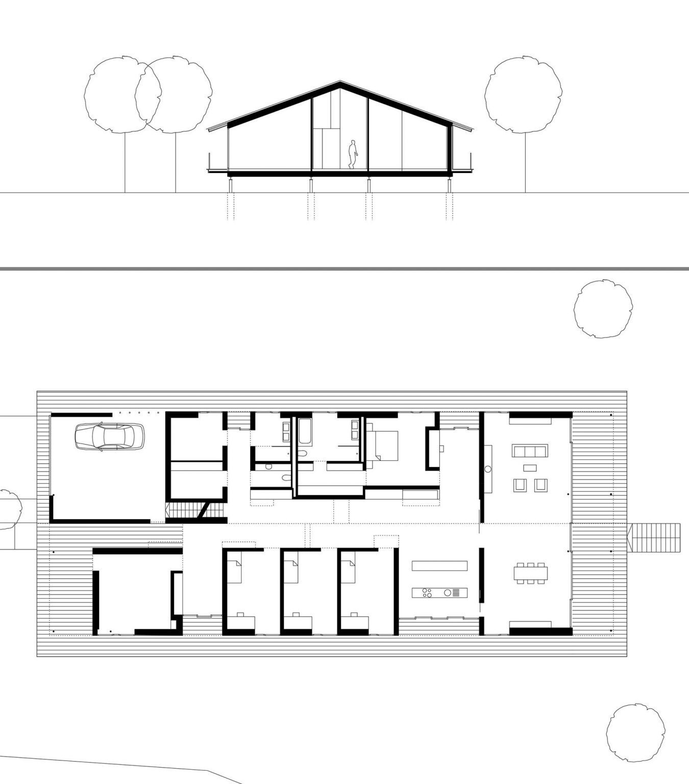 This modern German holiday home is divided into separate timber-clad volumes connected by bright glazed hallways.