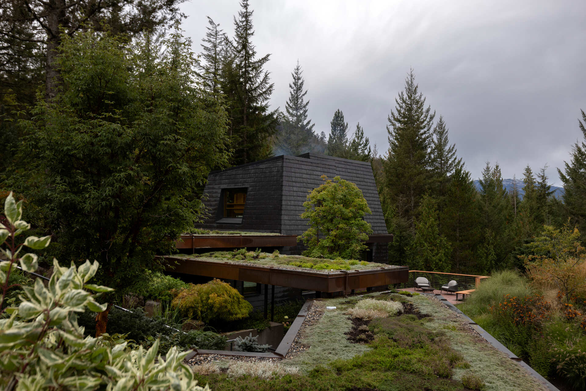 Cascading green roofs, copper-clad details, and forest-inspired materials make this Whistler mountain home feel tucked into the landscape.
