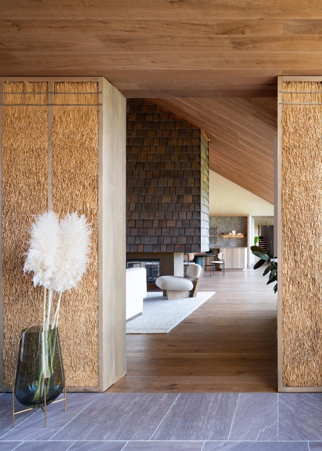 Oak interiors, plaster walls, and black-framed windows bring warmth and contrast to this relaxed modern home in Amagansett.