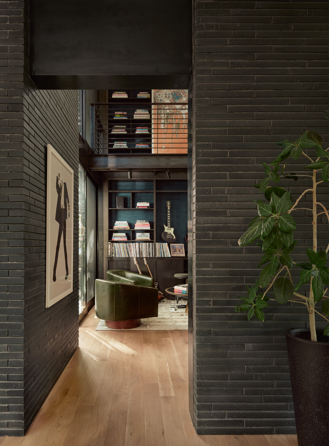 Rich materials, natural light, and curated details give the music room a warm and inviting atmosphere, creating a space designed for creativity, relaxation, and gathering.