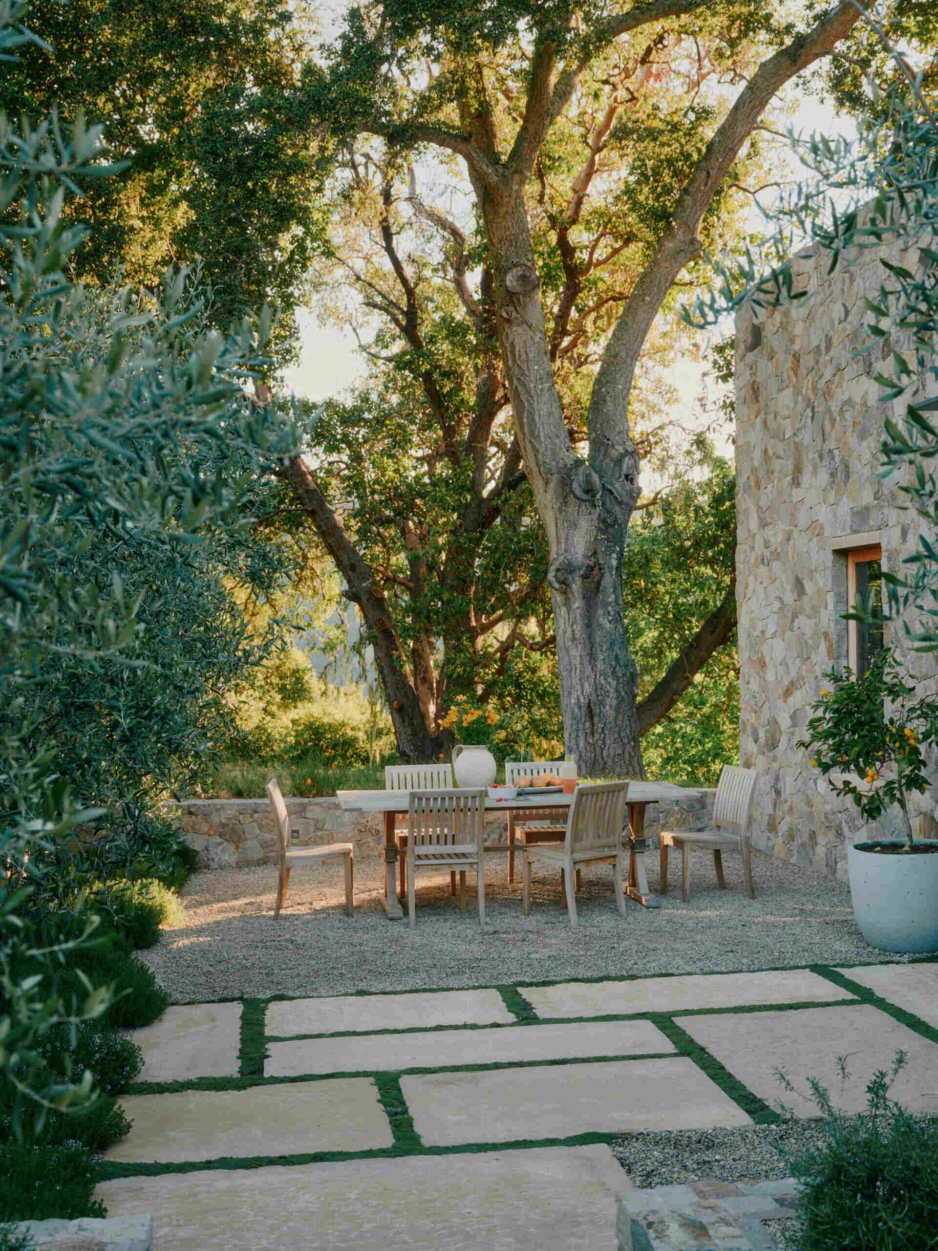 Firepit lounges, outdoor dining spaces, and breezeways make this modern stone villa ideal for open-air California living.