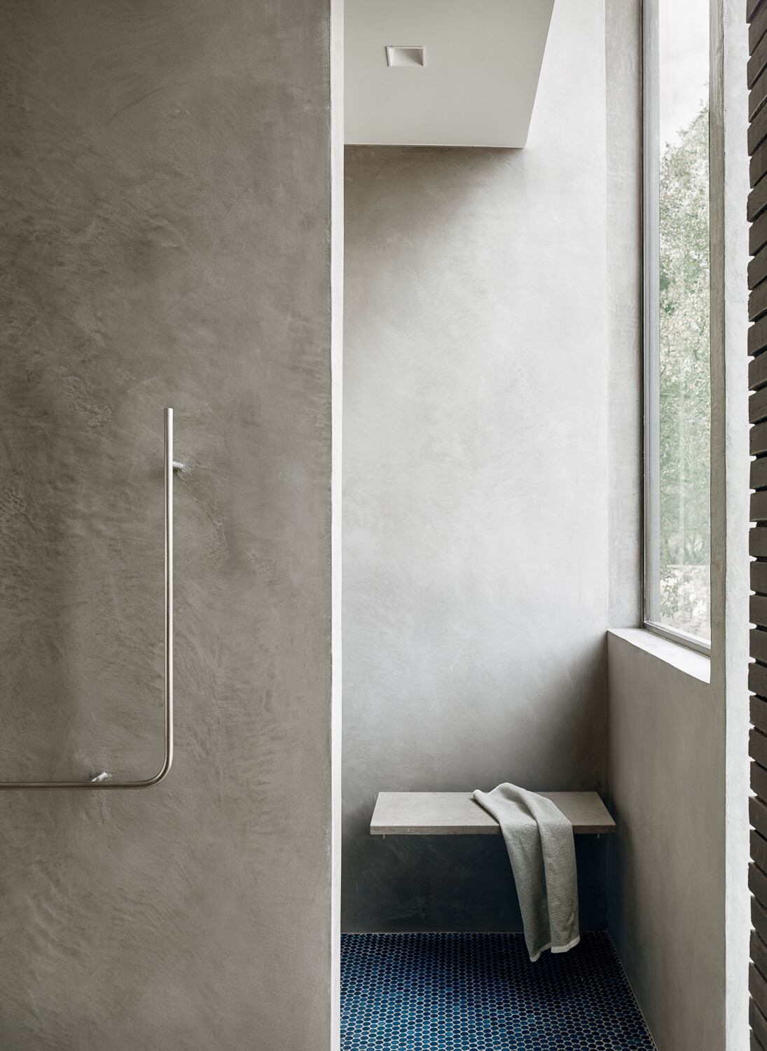 The primary bathroom continues the home's refined approach to materials, while clean lines and restrained detailing allow the quality of the finishes and design to take center stage.