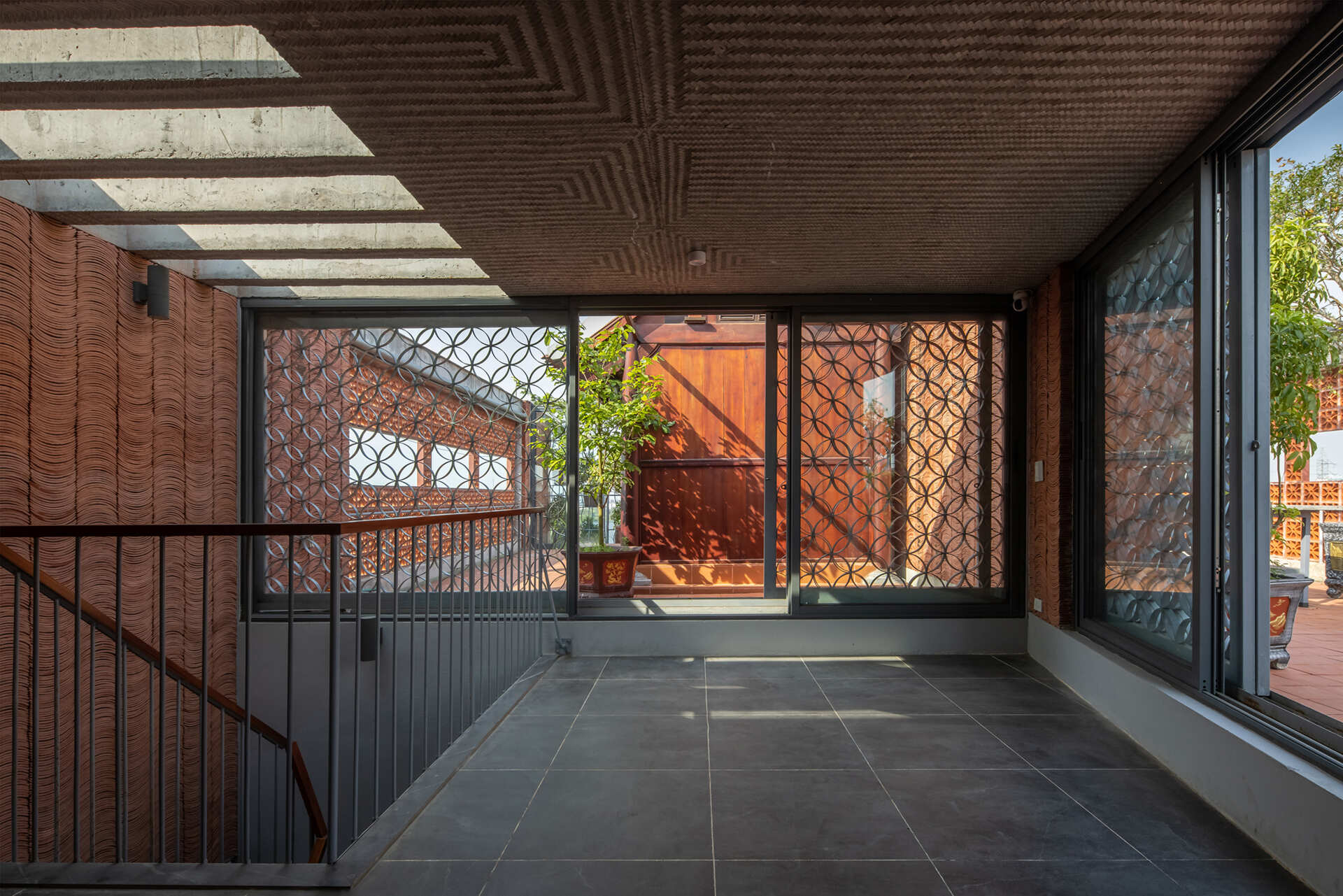A shared rooftop space provides a place for gathering above the layered facade.